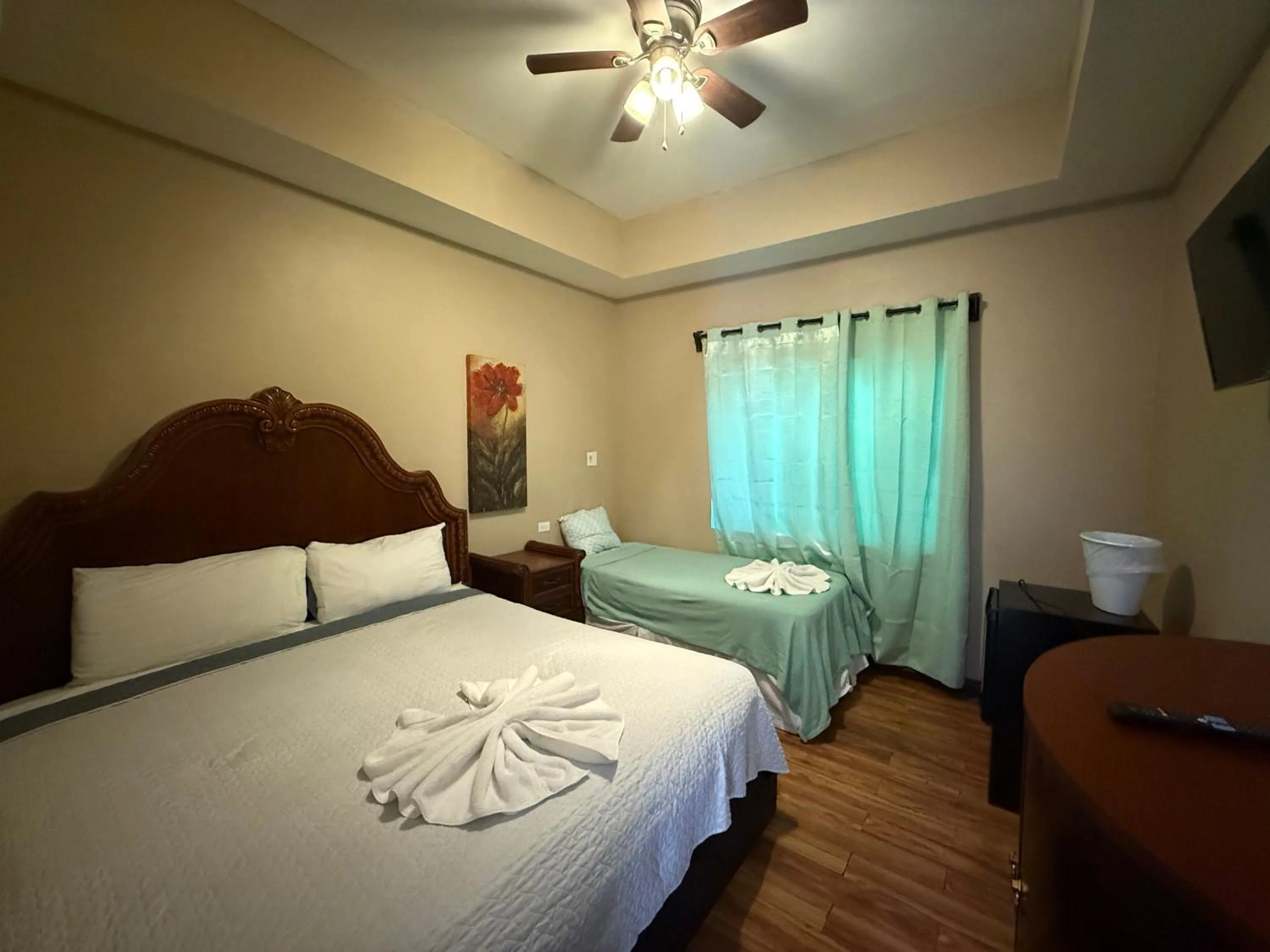 Bed in Hotel Royal Blue & Golf Cart Rental