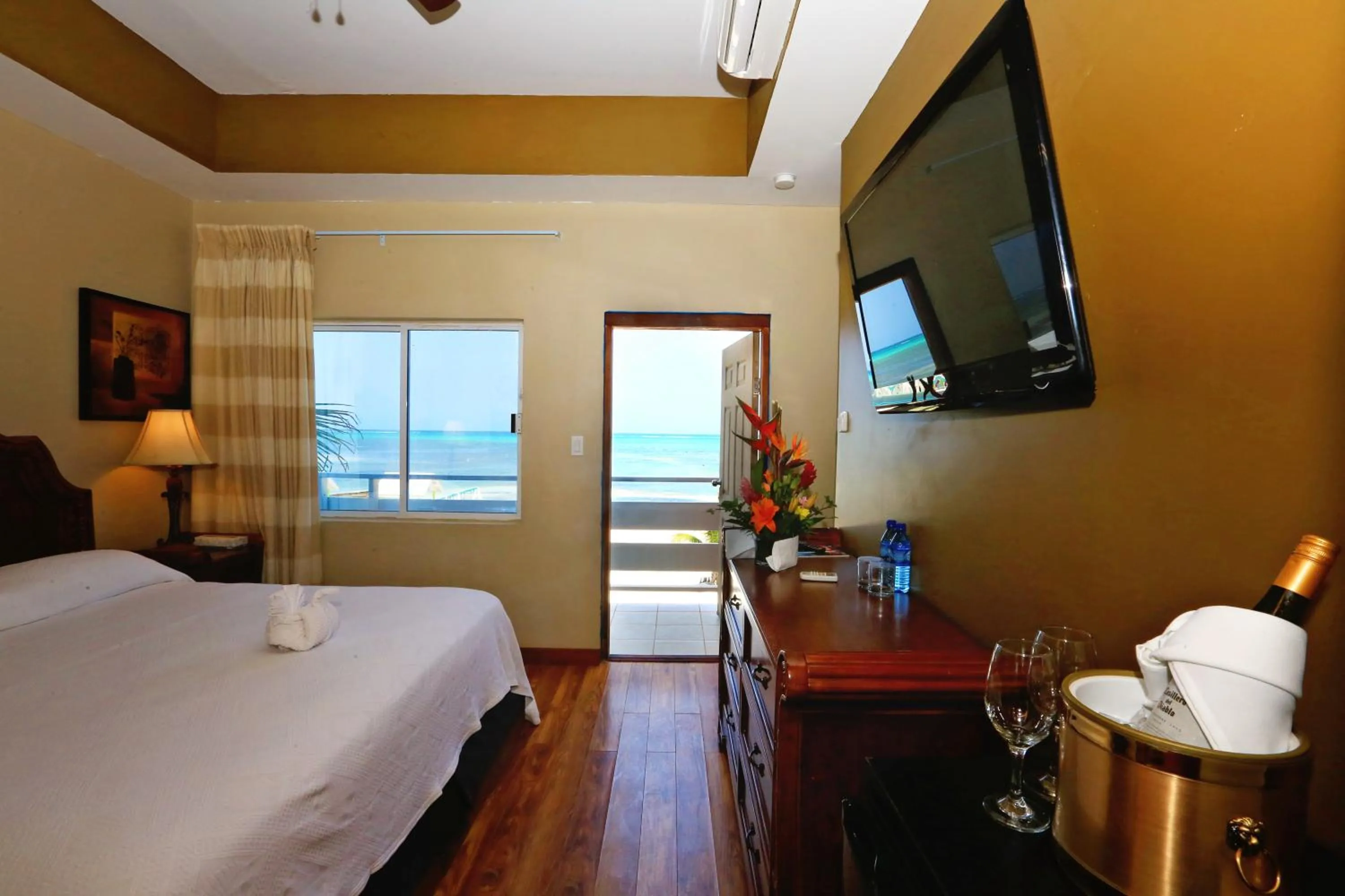 Bed in Hotel Royal Blue & Golf Cart Rental