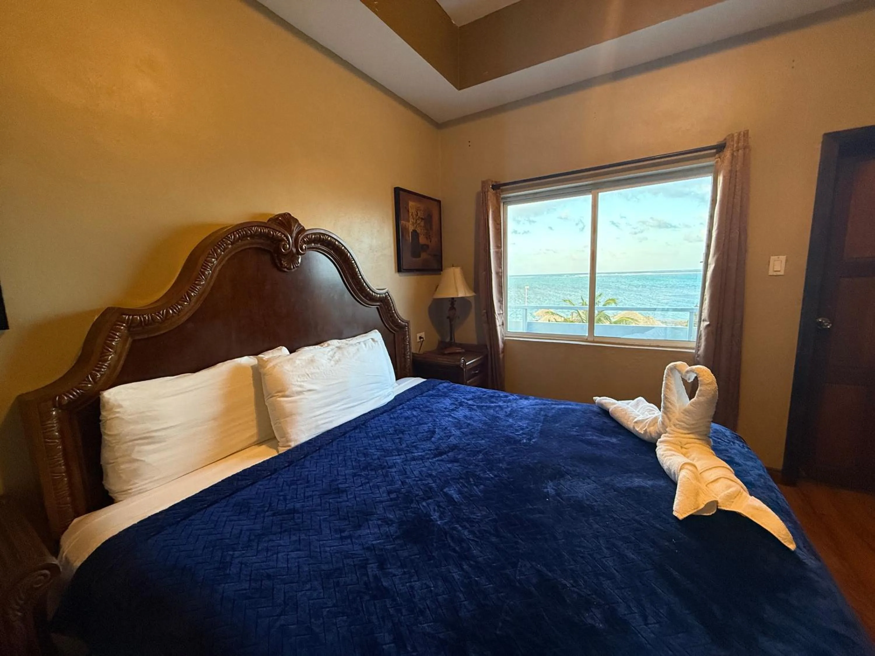 Bed in Hotel Royal Blue & Golf Cart Rental