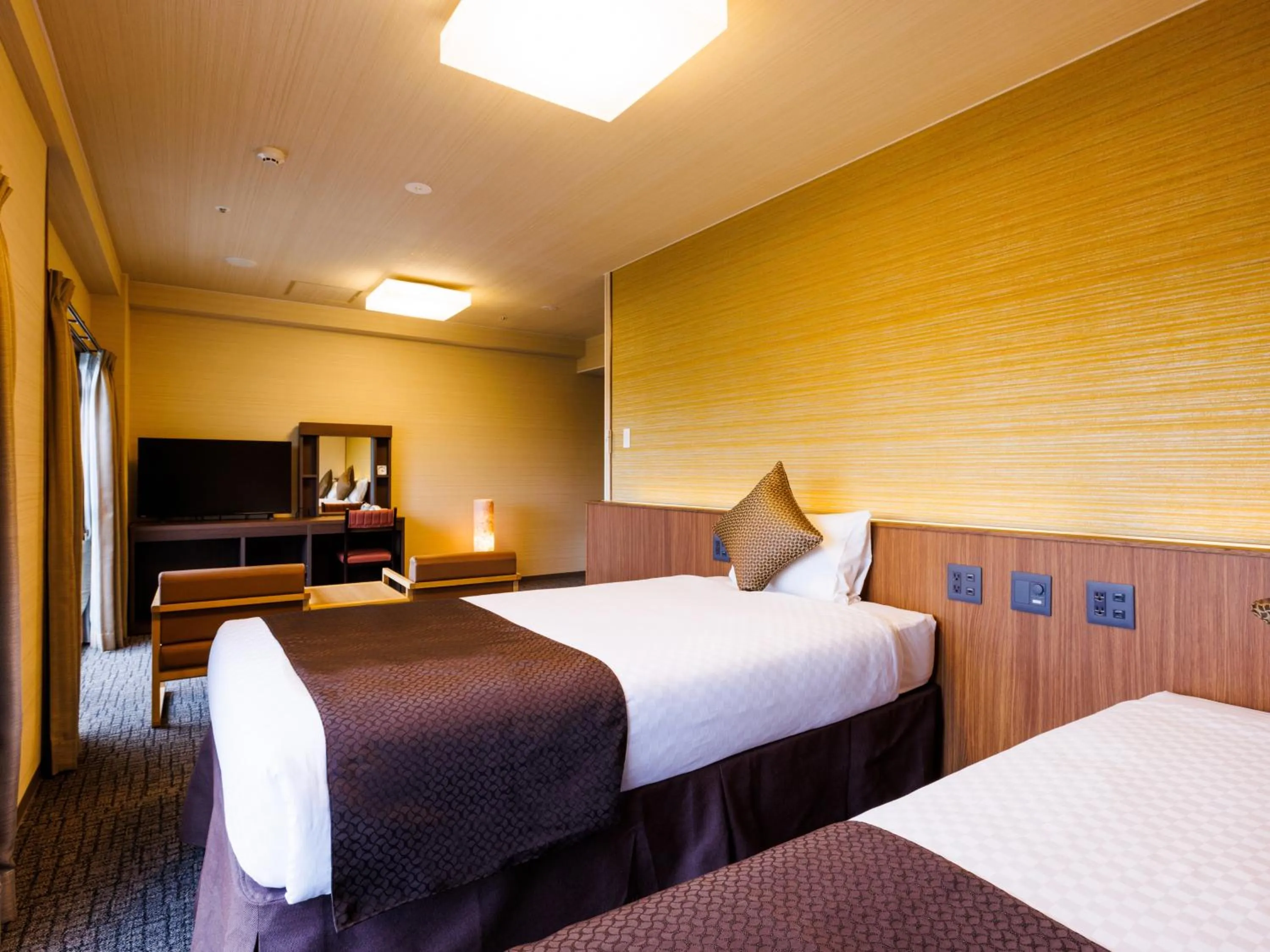 Bed in KAMENOI HOTEL Yamato Heguri