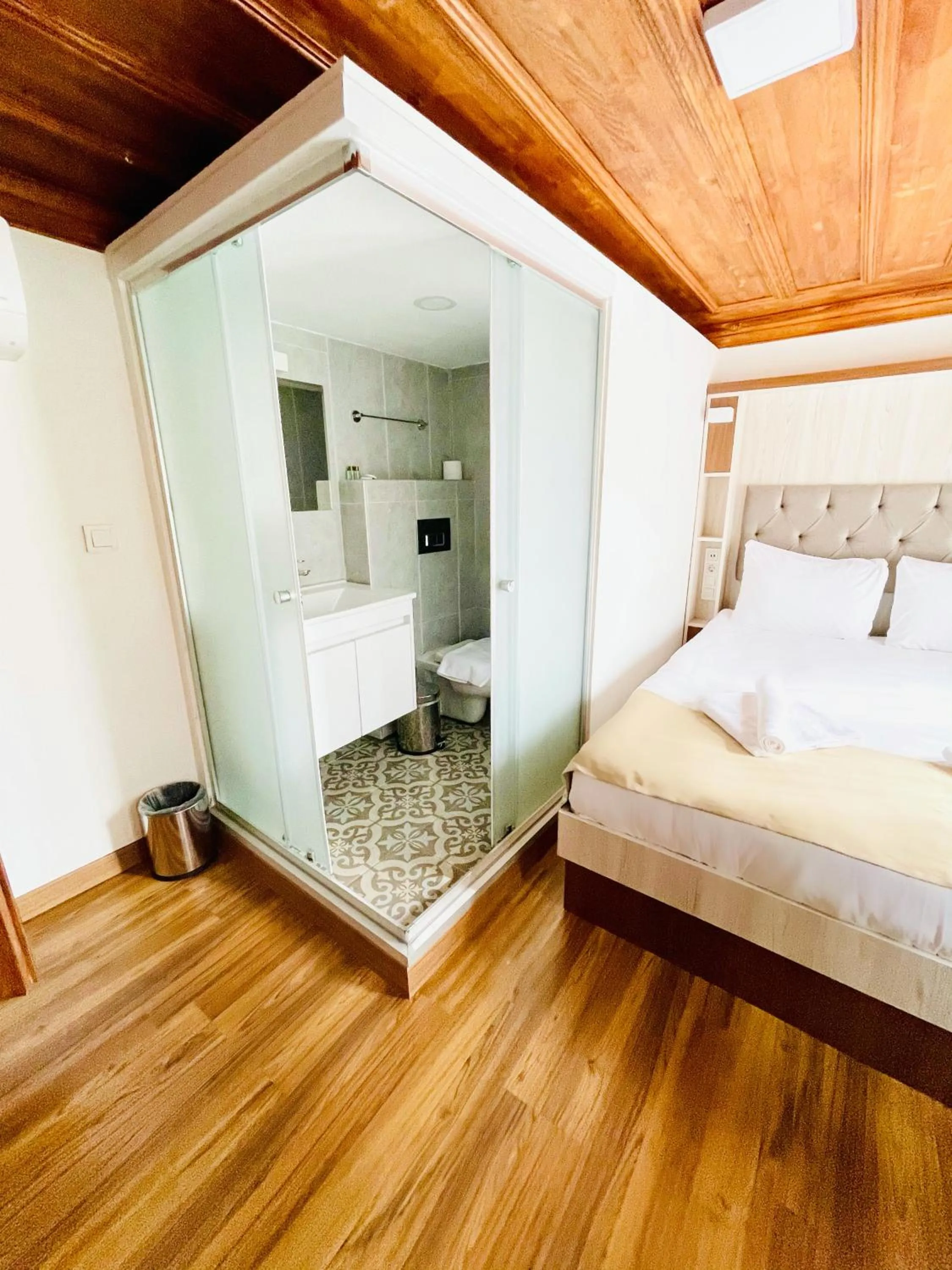 Bed in QONAQ HOTEL & SUITES