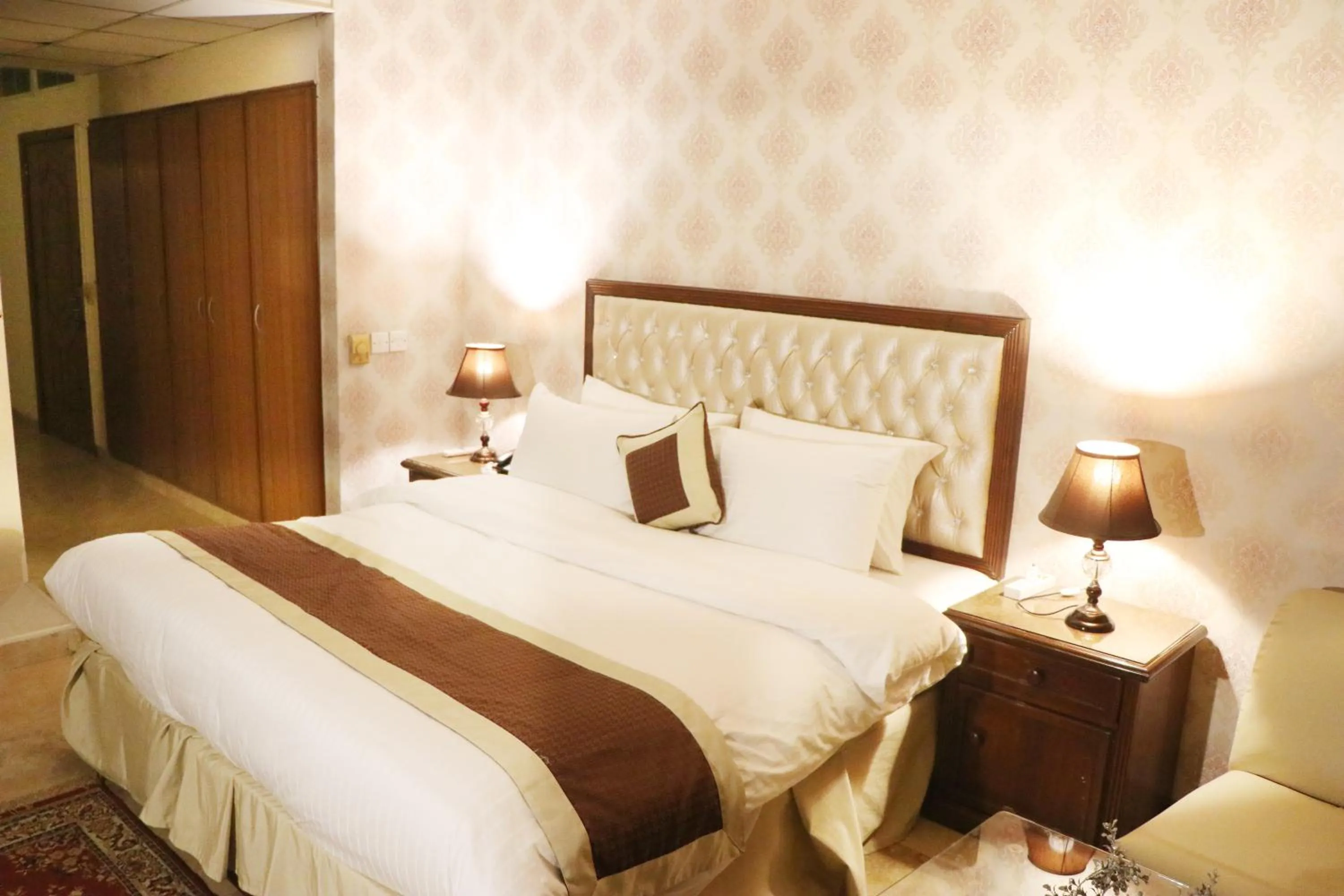 Bed in Shalimar Tower Hotel Lahore