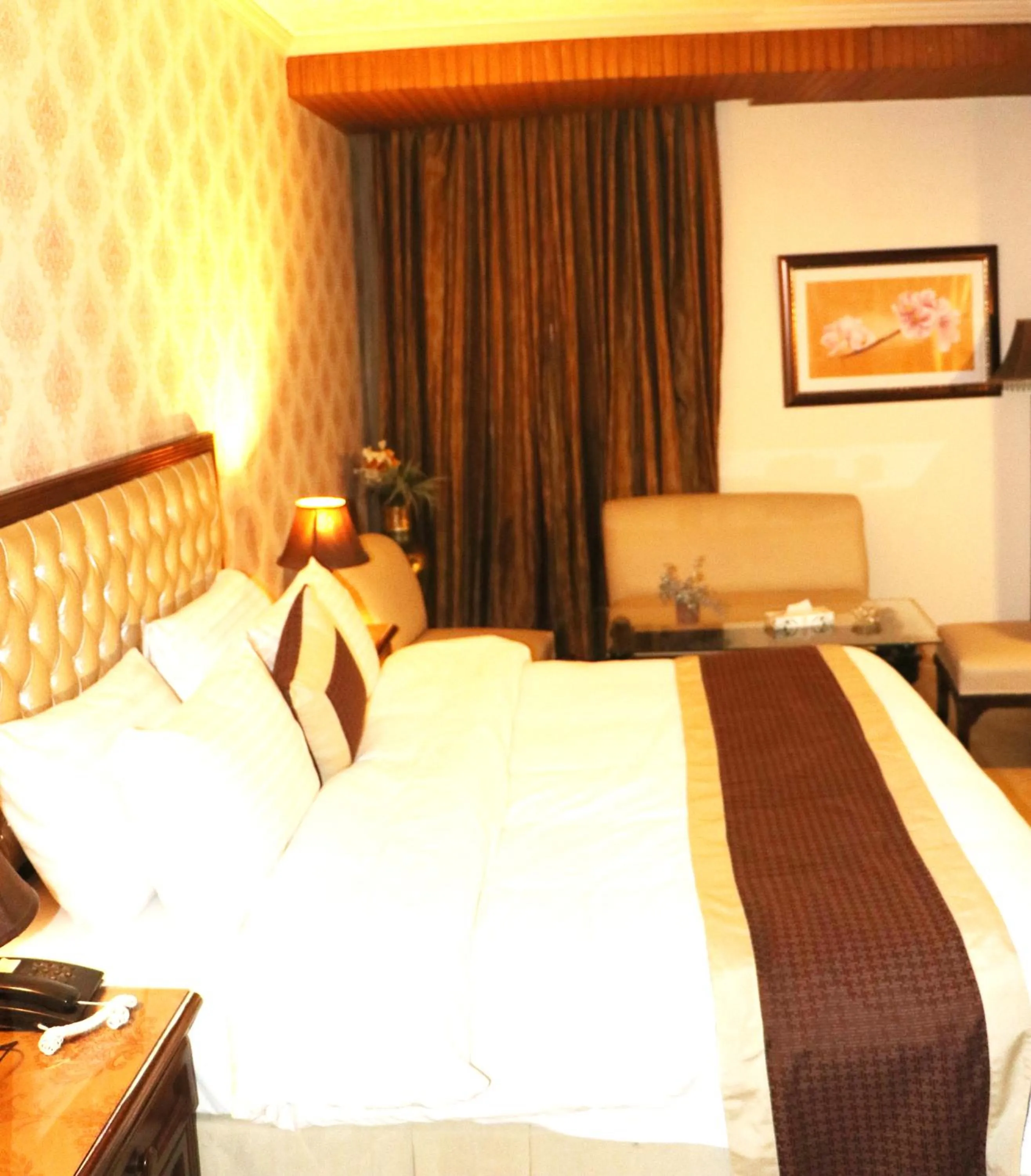 Bed in Shalimar Tower Hotel Lahore