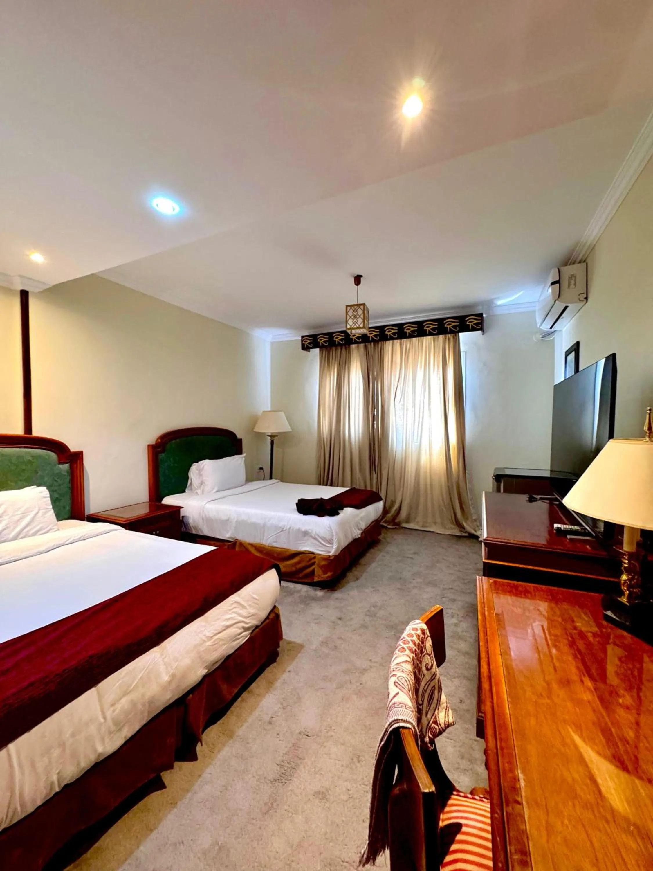 Communal lounge/ TV room, Bed in PYRAMIDS TOWER Inn