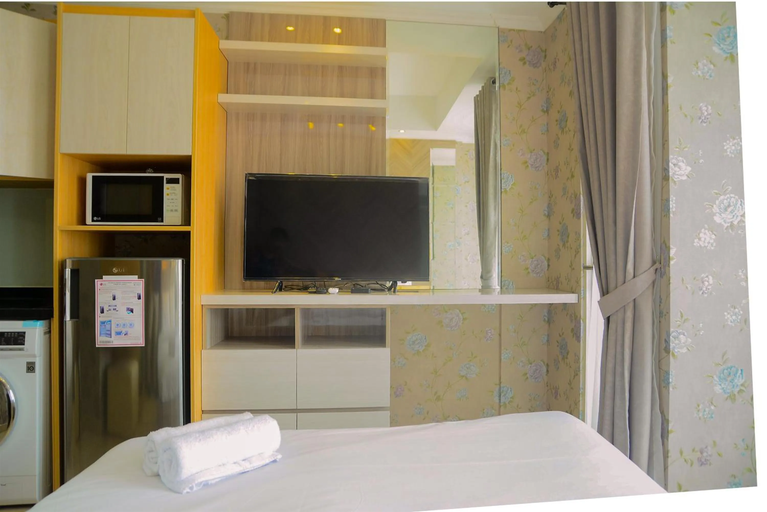 Bed in Tranquil Studio Apartment at Menteng Park By Travelio