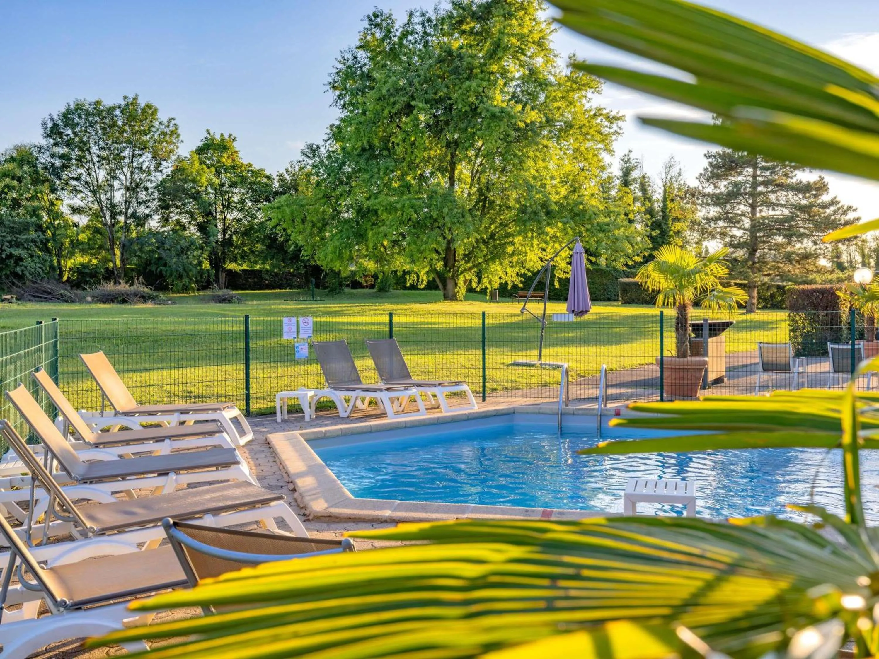 Pool view in Mercure Lyon Est Villefontaine