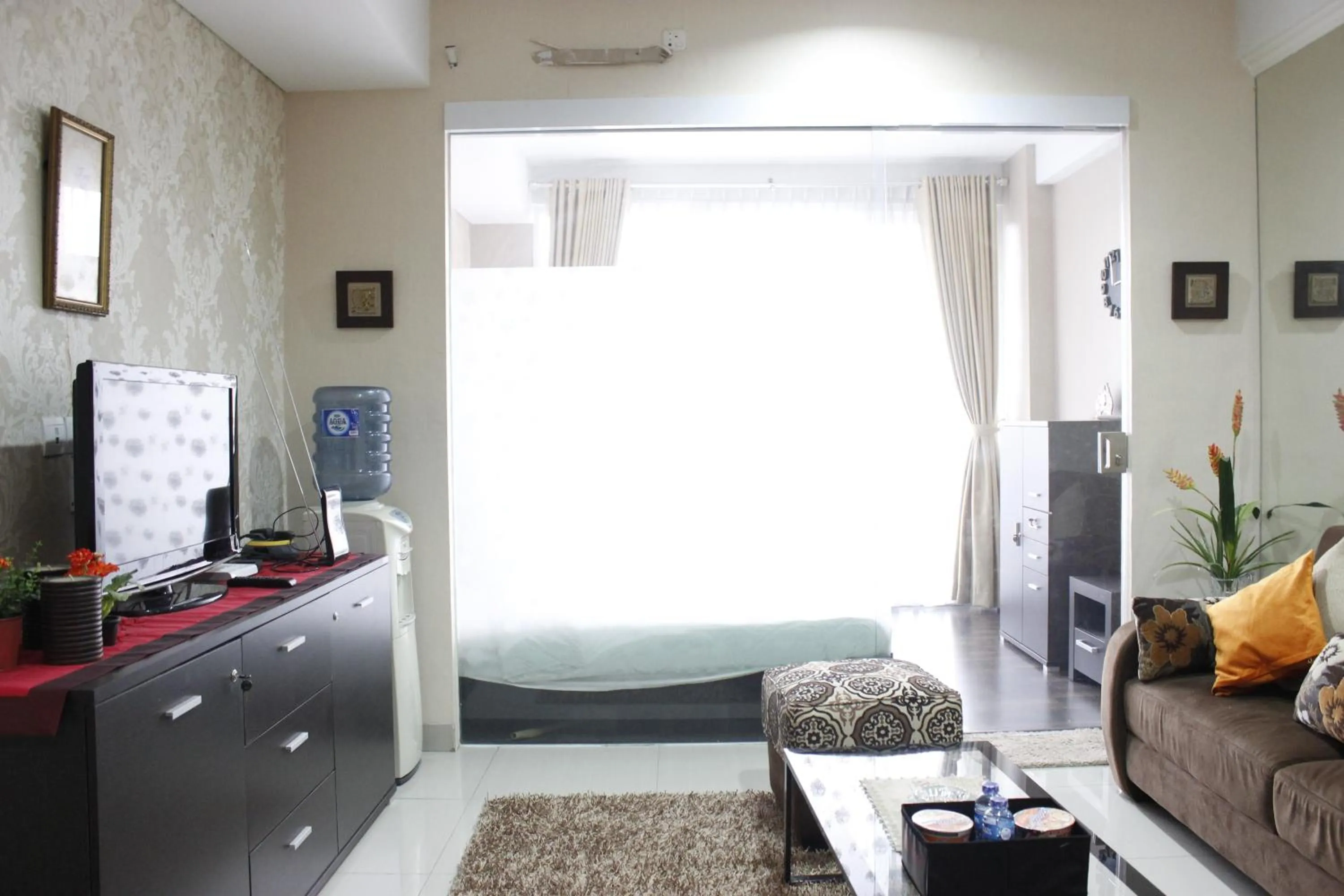 Living room, Bed in Stylish 1BR near ITB University at Dago Suites Apartment By Travelio