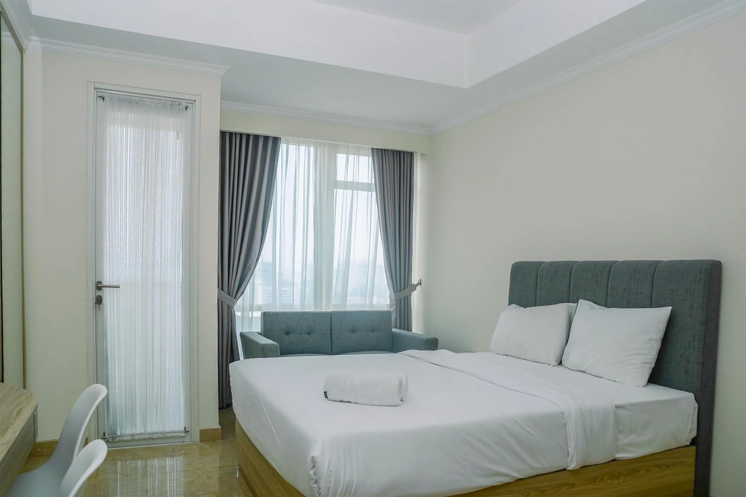 Bed in Modern and Cozy Studio Menteng Park Apartment By Travelio