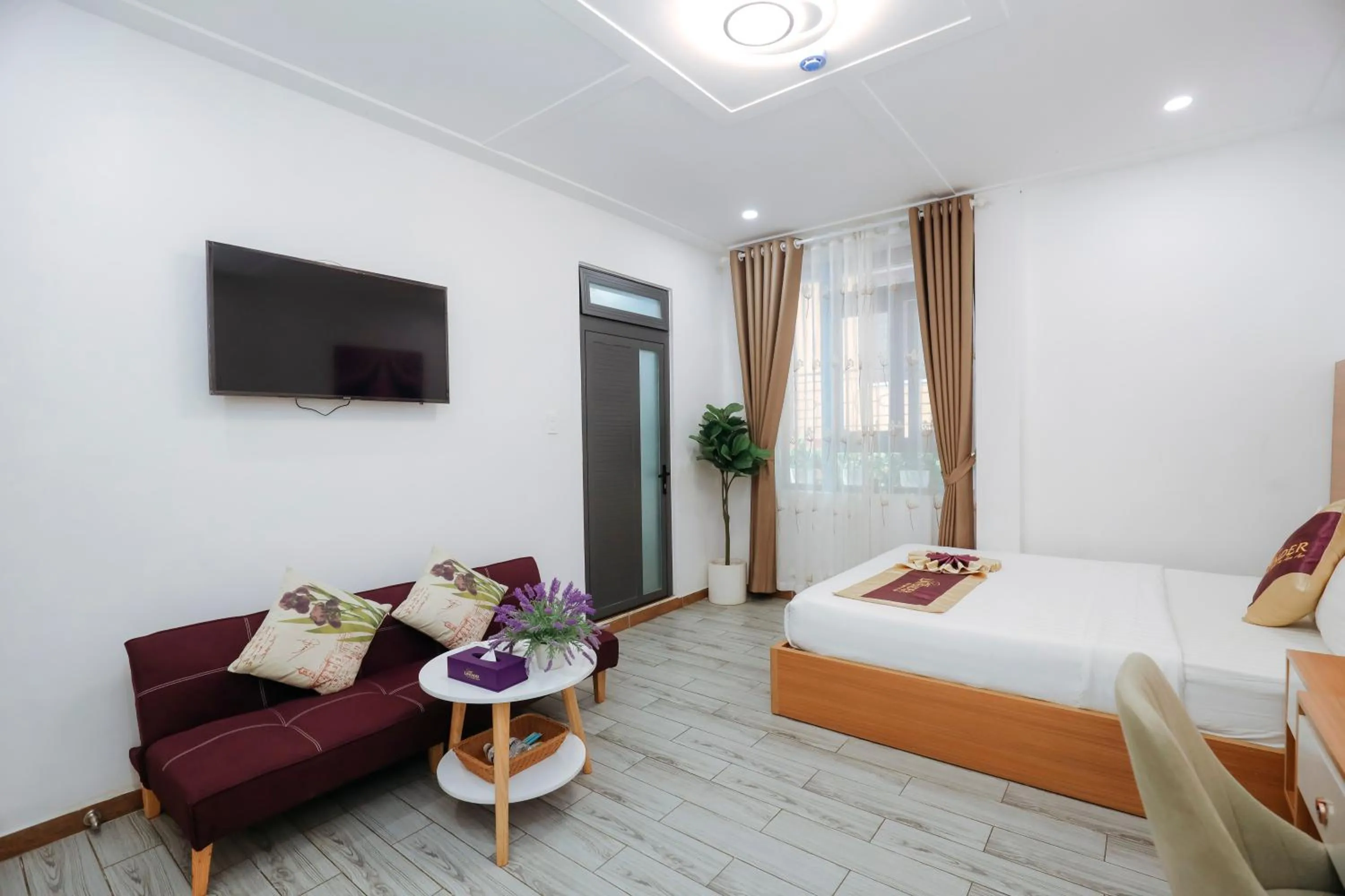 Communal lounge/ TV room, Bed in Sweet Lavender Hotel