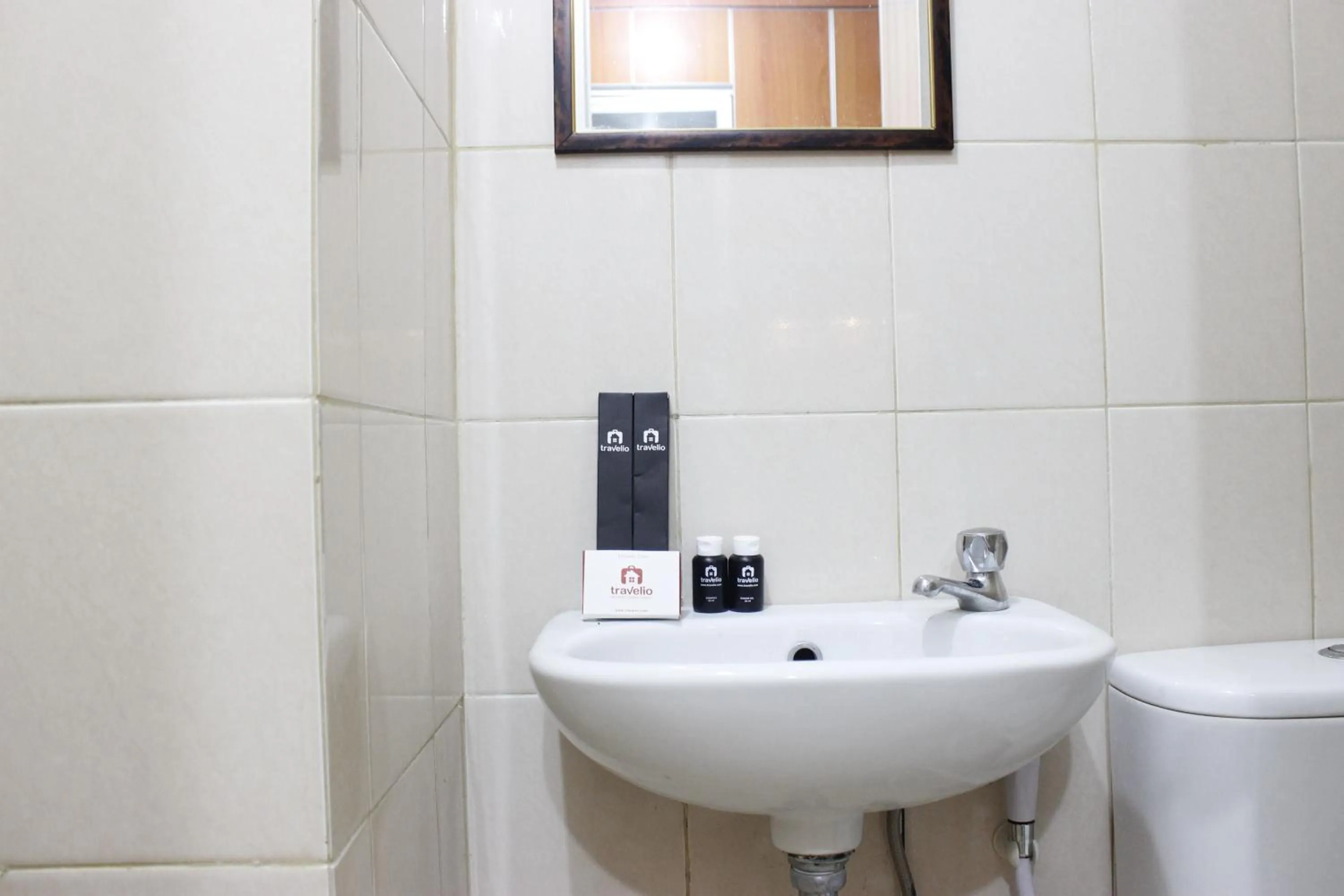 Bathroom in Compact Studio Tamansari Panoramic Apartment By Travelio