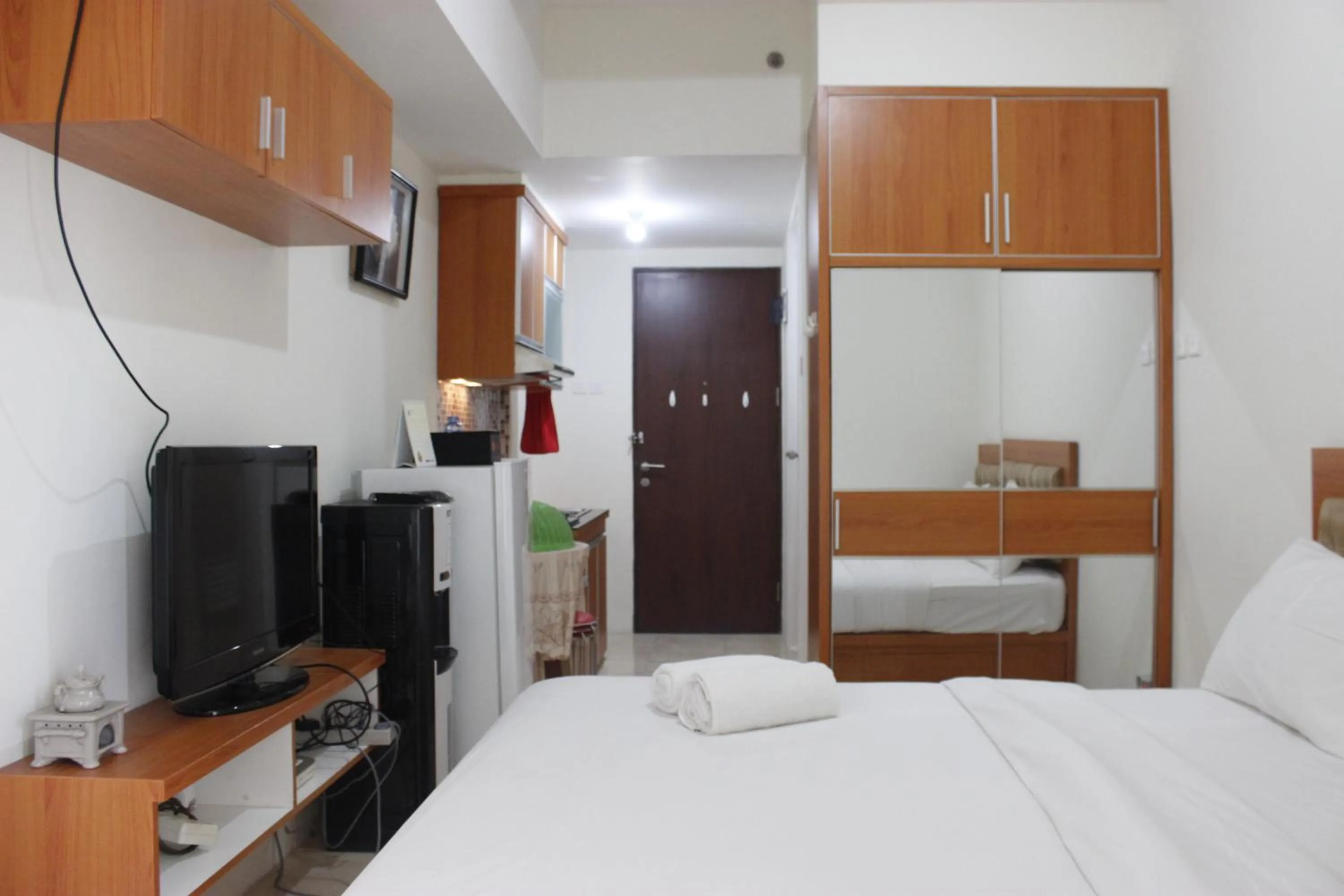 Bed in Compact Studio Tamansari Panoramic Apartment By Travelio