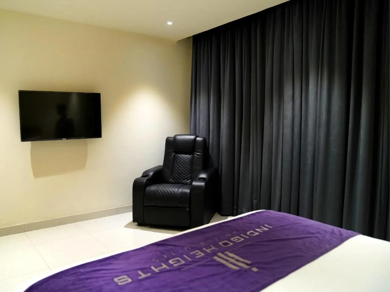 Seating area, Bed in Indigo Heights Hotel & Suites