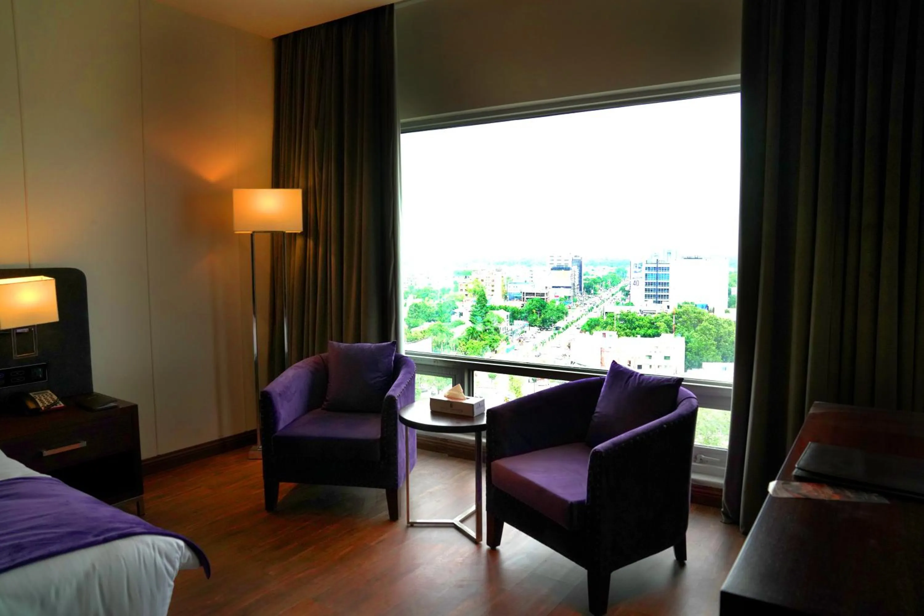 Seating area, Bed in Indigo Heights Hotel & Suites