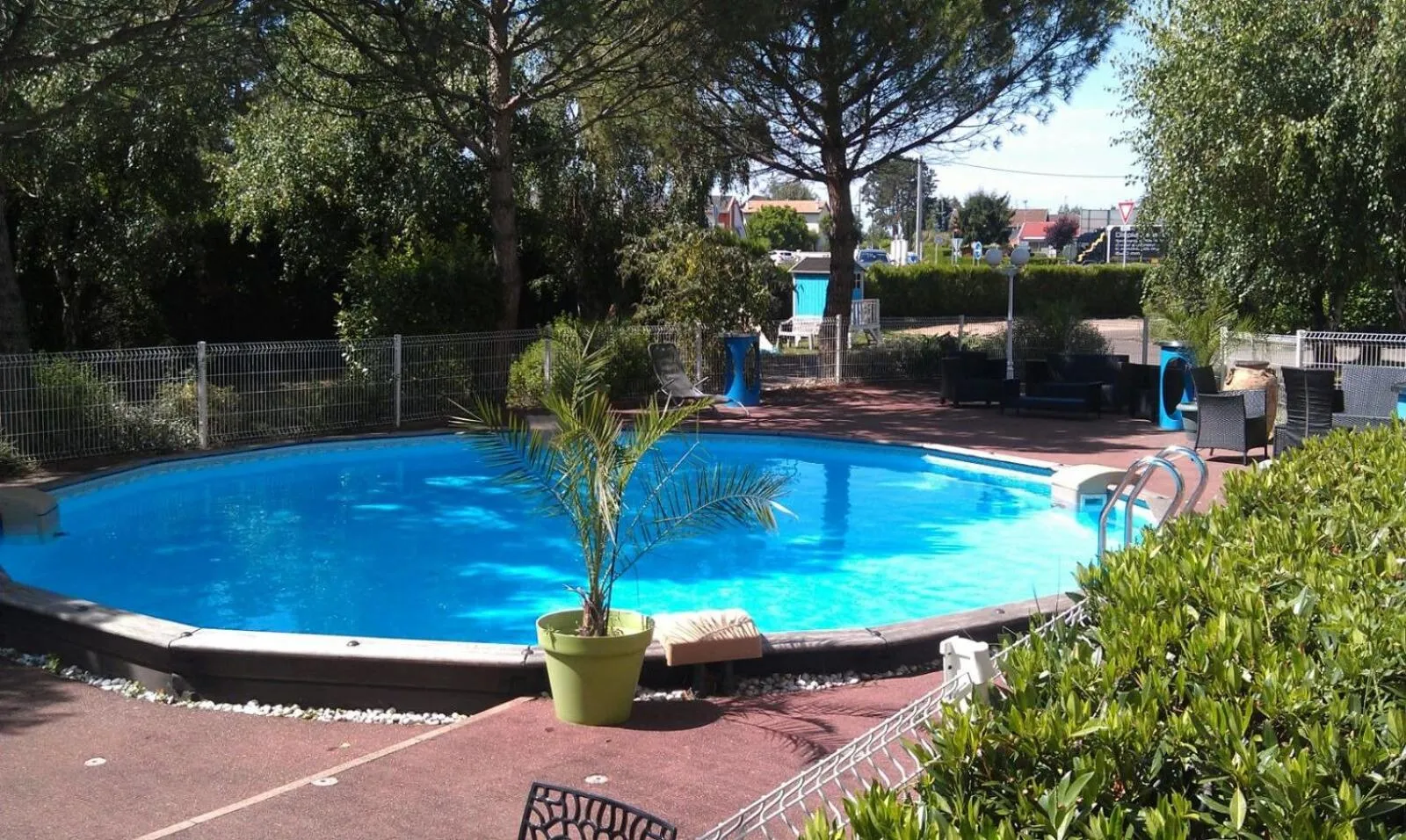 Swimming pool in Logis Les Charmilles Chalon-sur-Saône Sud