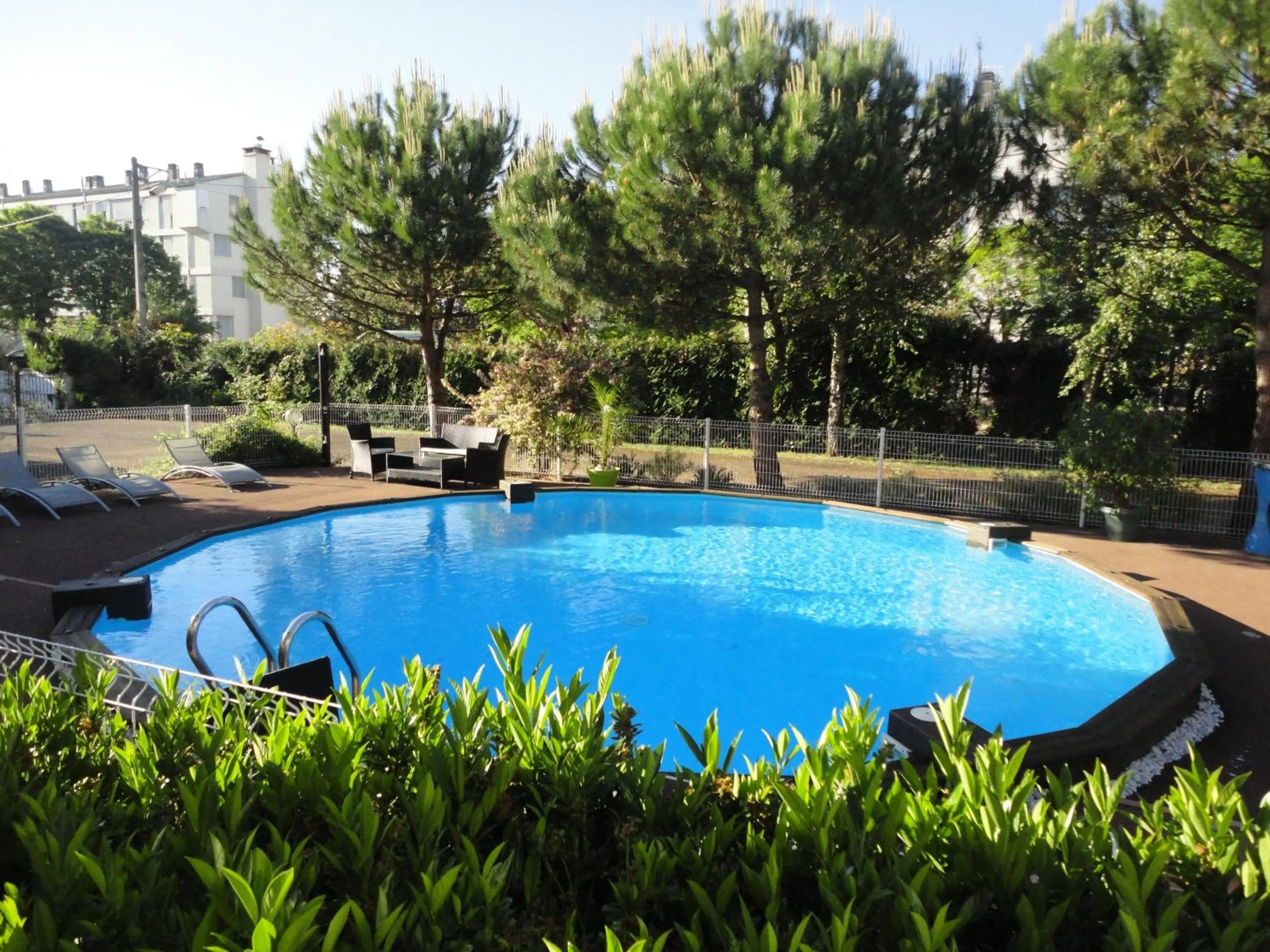 Swimming pool in Logis Les Charmilles Chalon-sur-Saône Sud