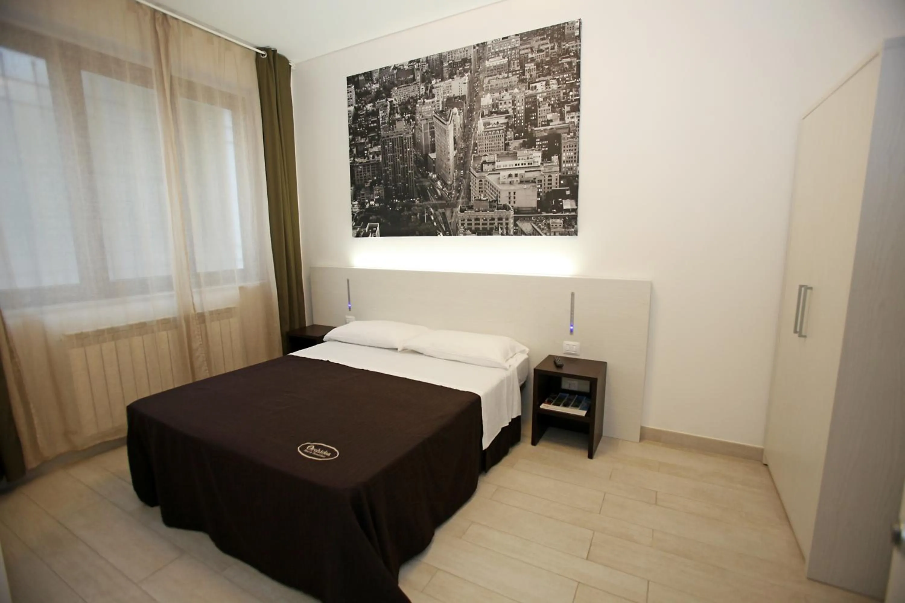 Bed in Orchidea Rooms & Suites