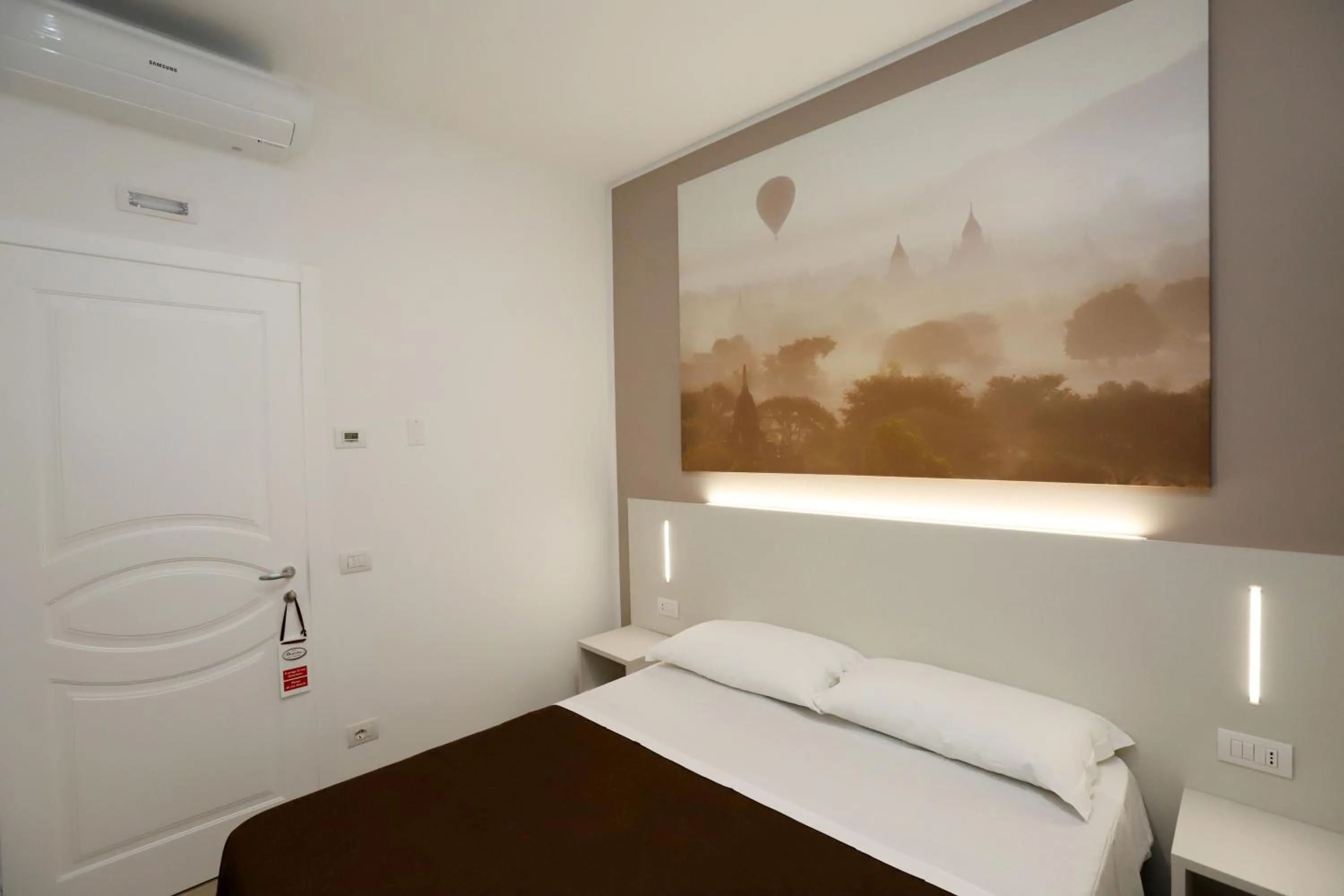 Bed in Orchidea Rooms & Suites