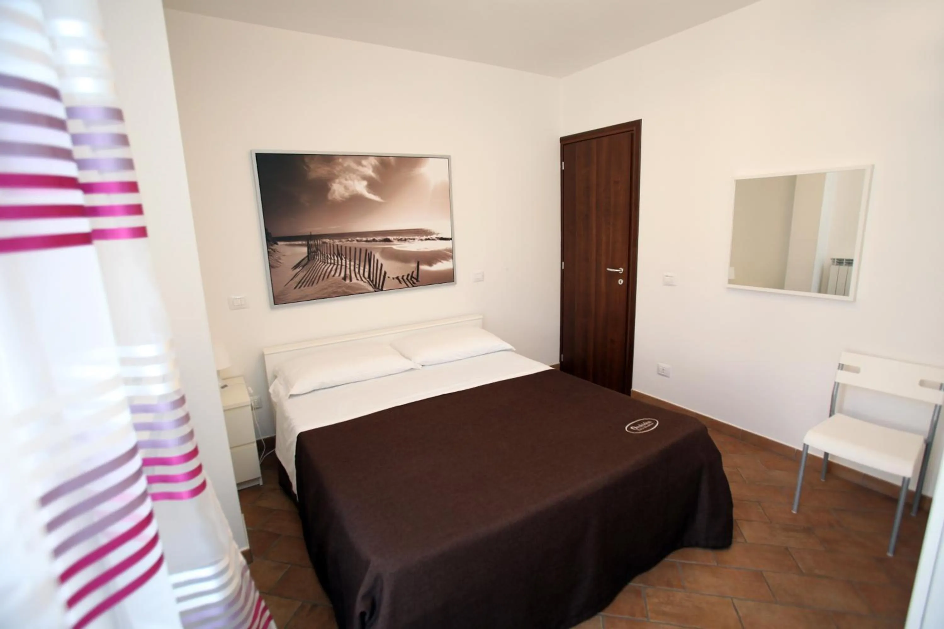 Bed in Orchidea Rooms & Suites