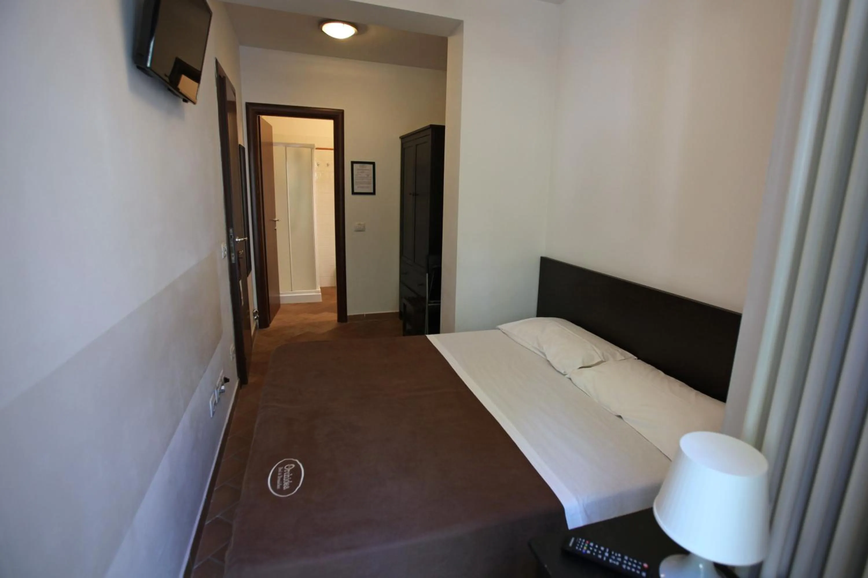 Bed in Orchidea Rooms & Suites