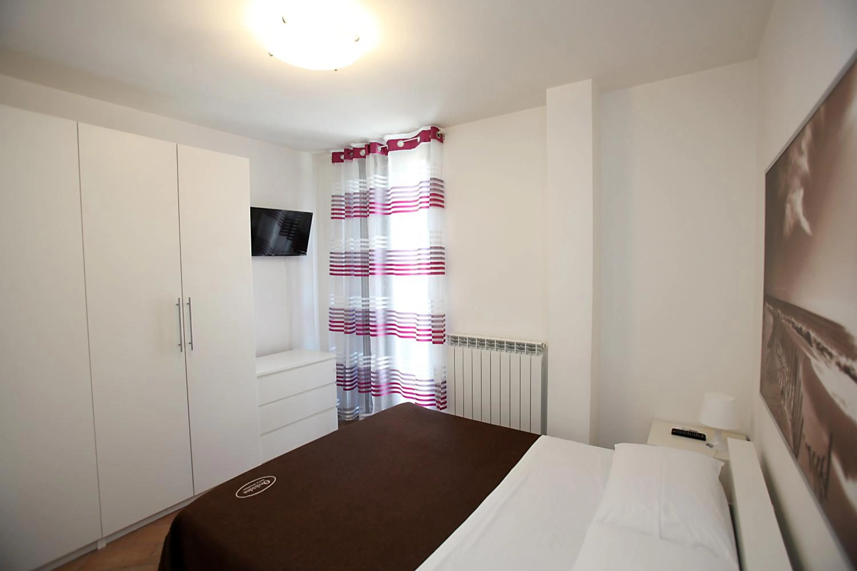 Bed in Orchidea Rooms & Suites