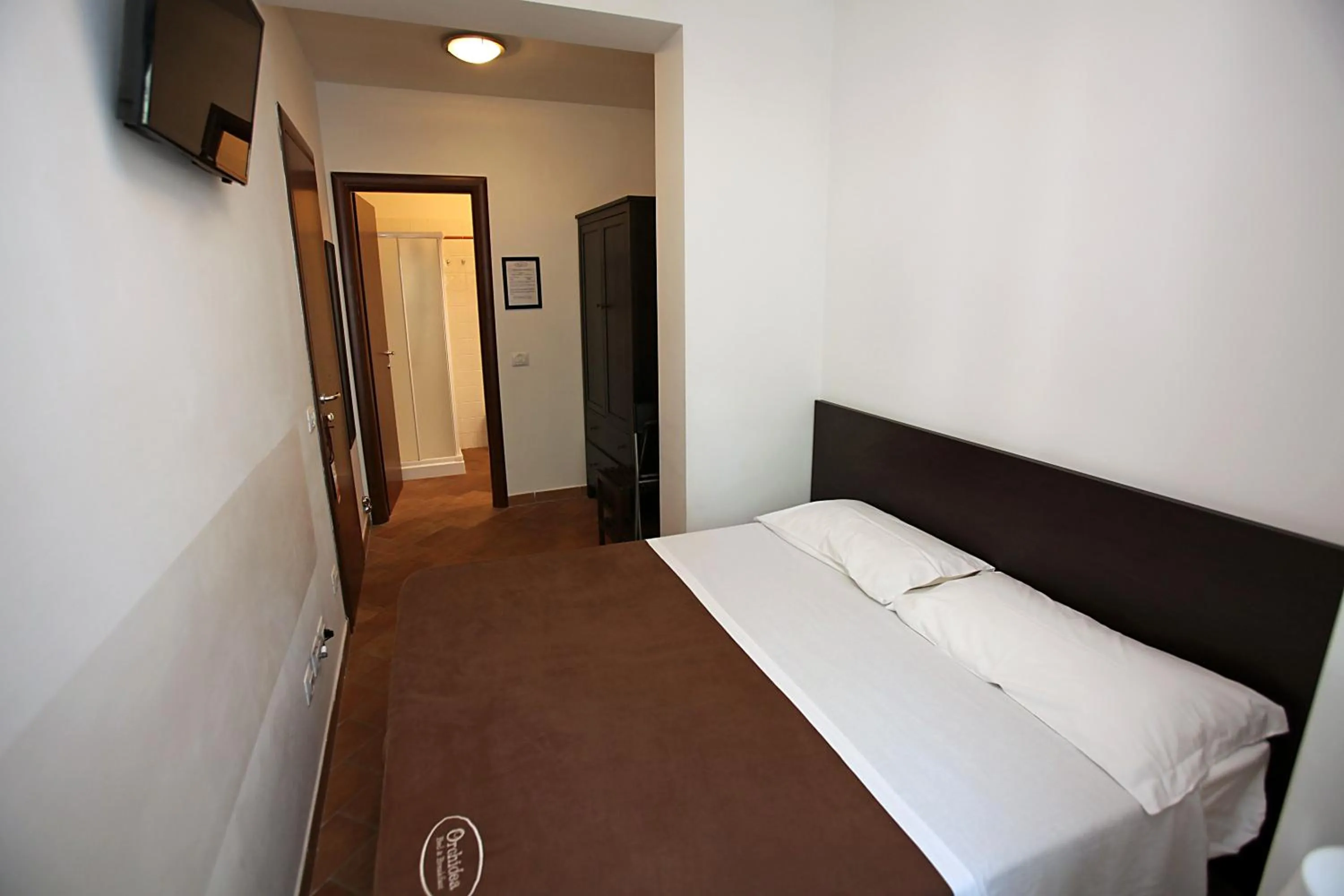 Bed in Orchidea Rooms & Suites