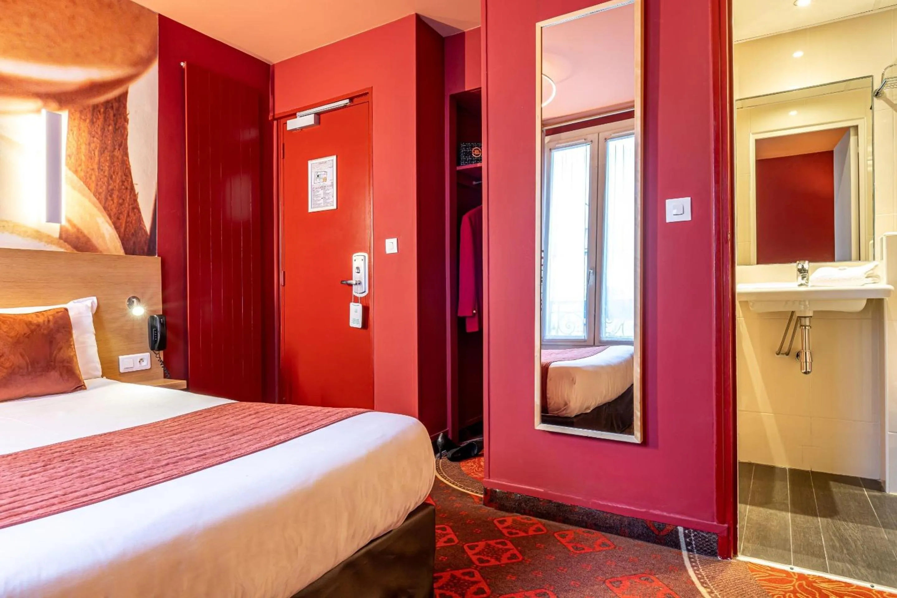 Bed in Hotel Ariane Montparnasse by Patrick Hayat