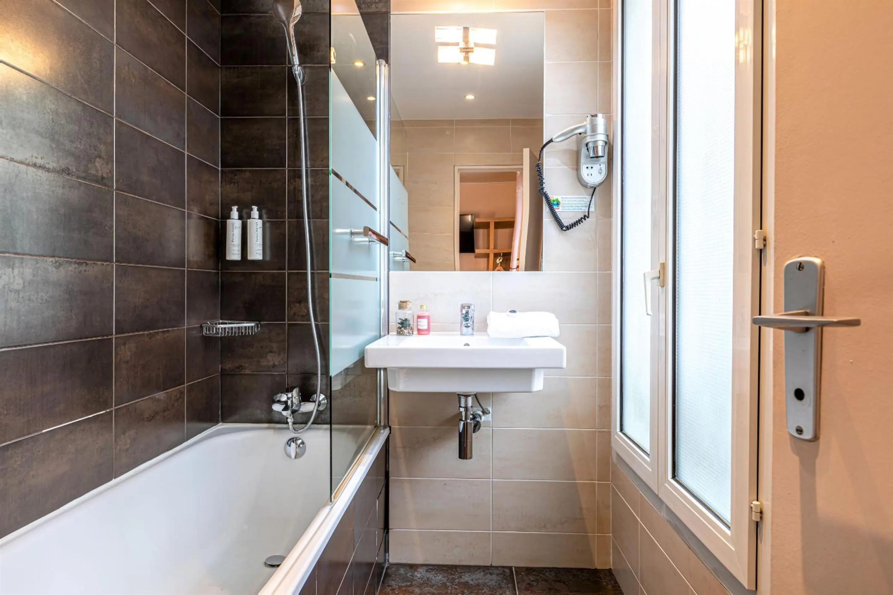 Bathroom in Hotel Ariane Montparnasse by Patrick Hayat