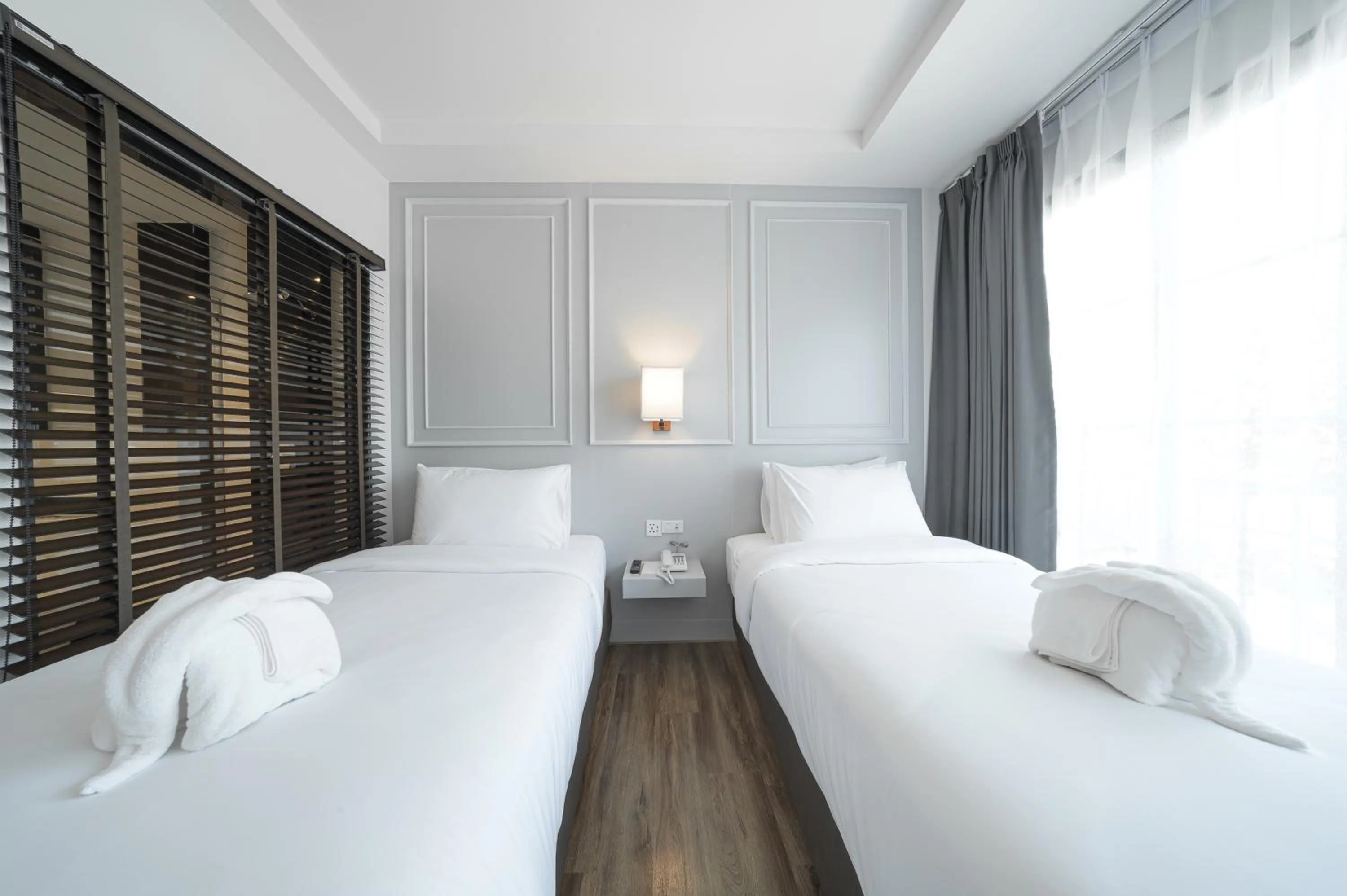 Bed in The Wing Boutique Hotel