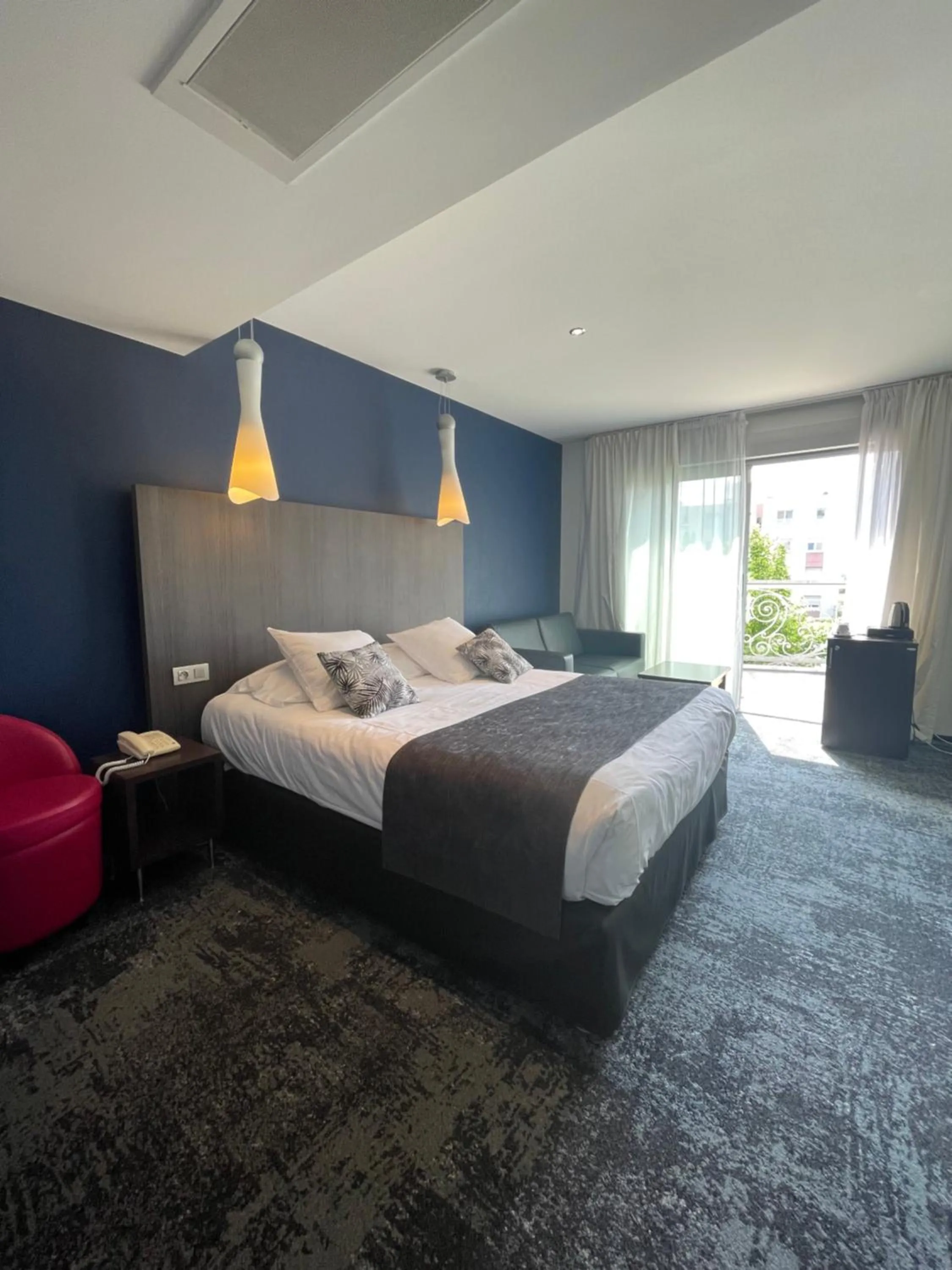 Photo of the whole room, Bed in Logis Hôtel Victor Hugo & Spa