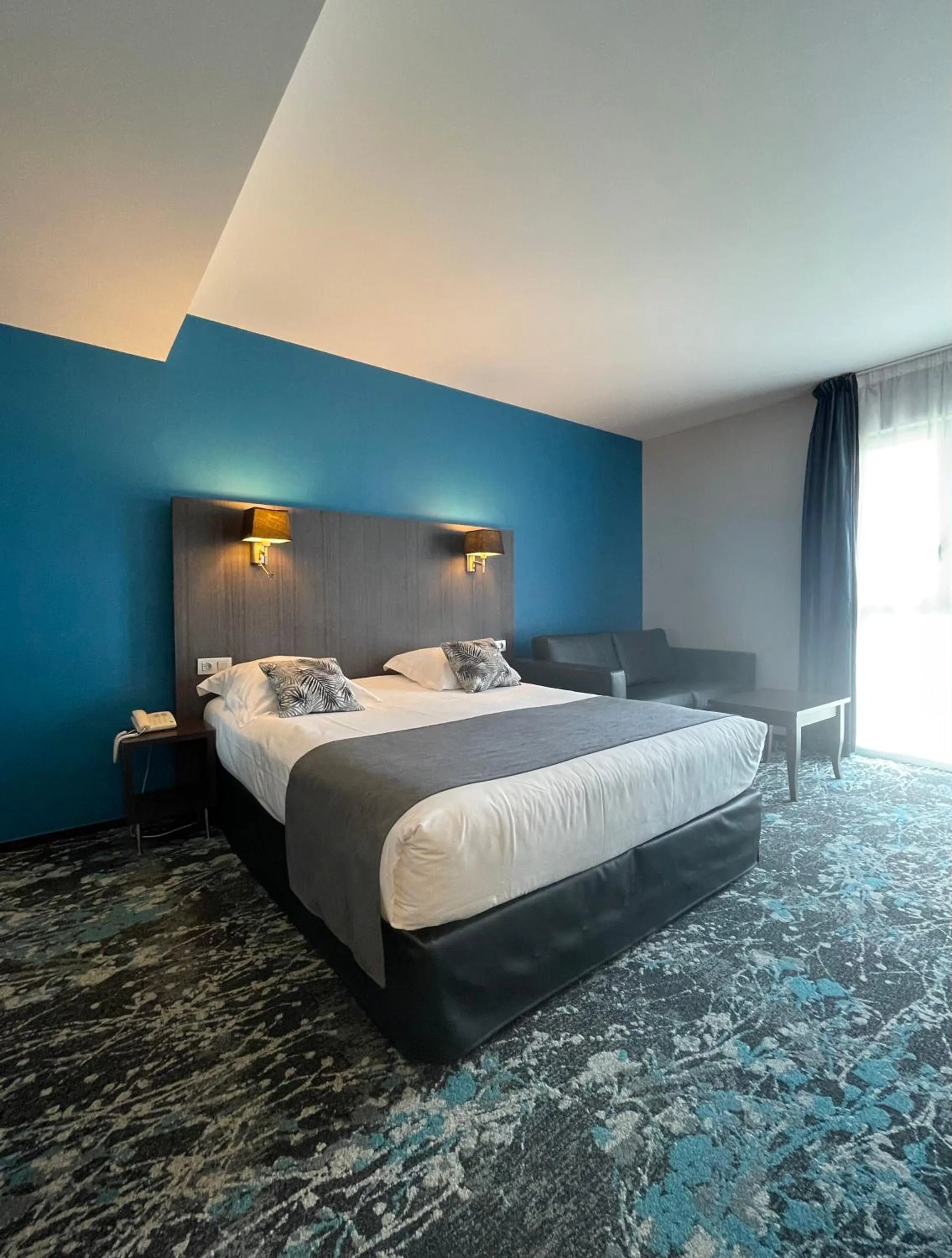 Photo of the whole room, Bed in Logis Hôtel Victor Hugo & Spa