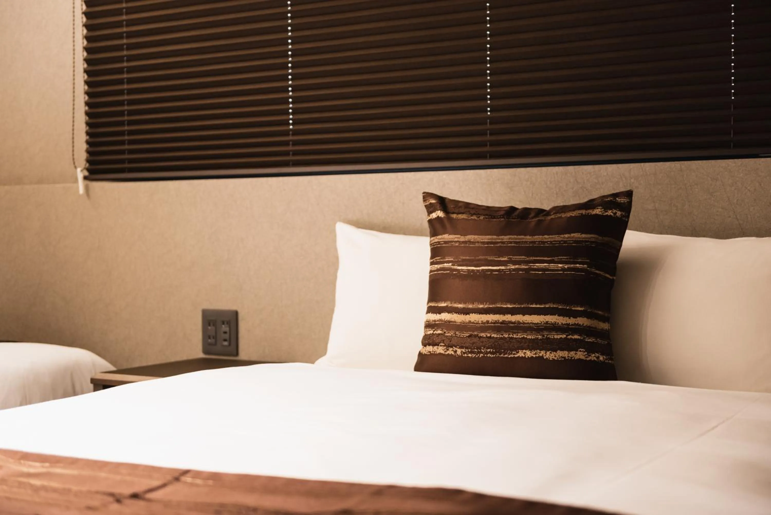 Bed in GRAND BASE Beppu Ekihigashi