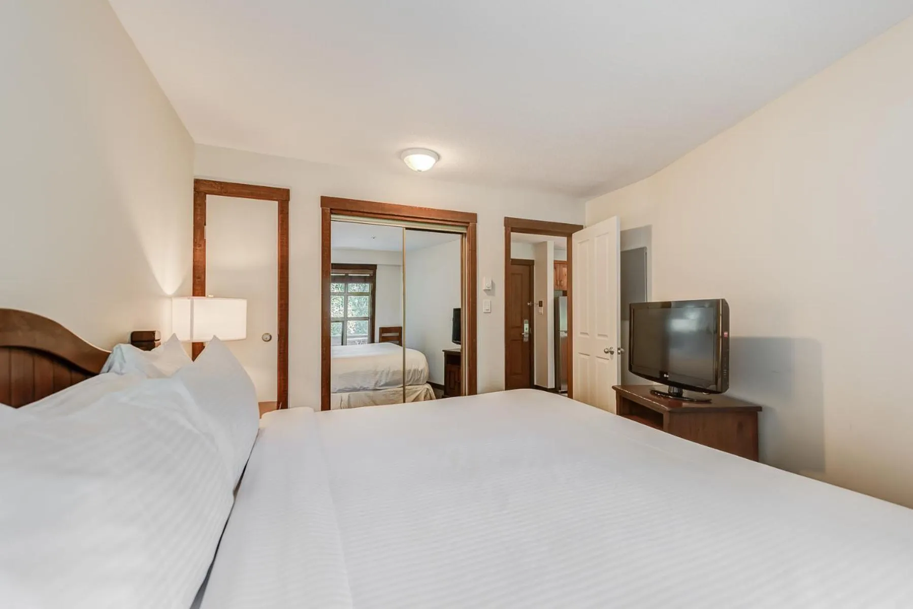 Bed in Blackcomb Springs Suites by CLIQUE