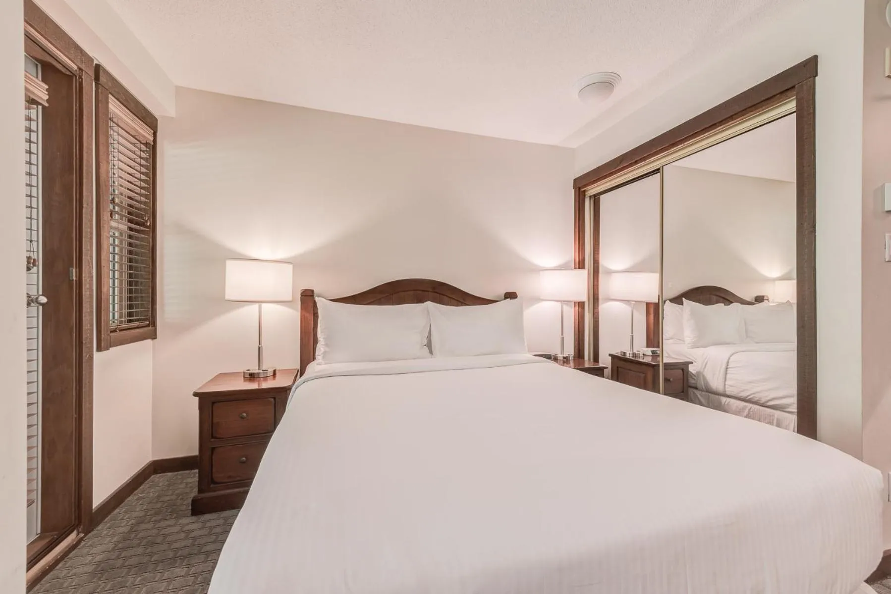 Bed in Blackcomb Springs Suites by CLIQUE