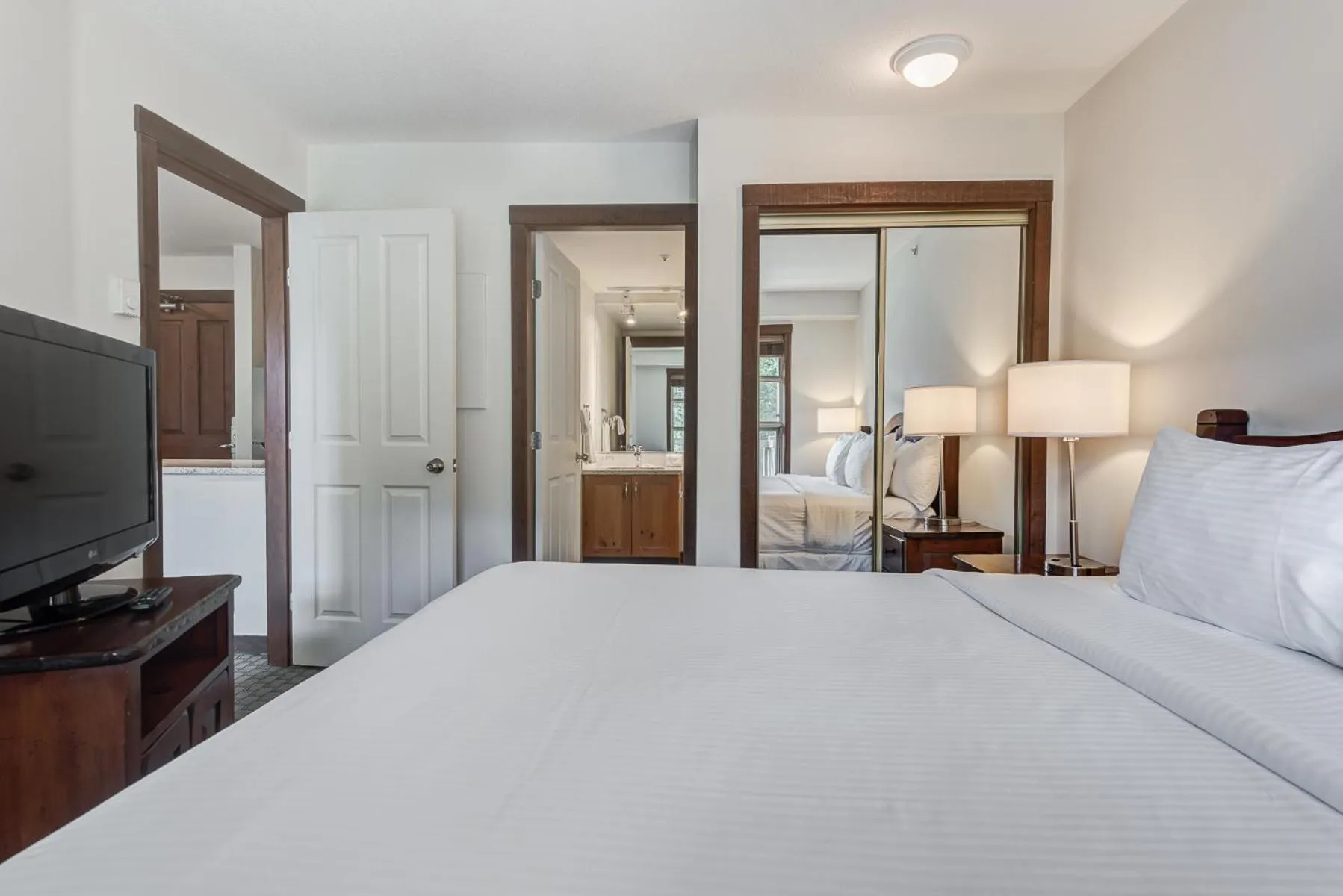 Bed in Blackcomb Springs Suites by CLIQUE