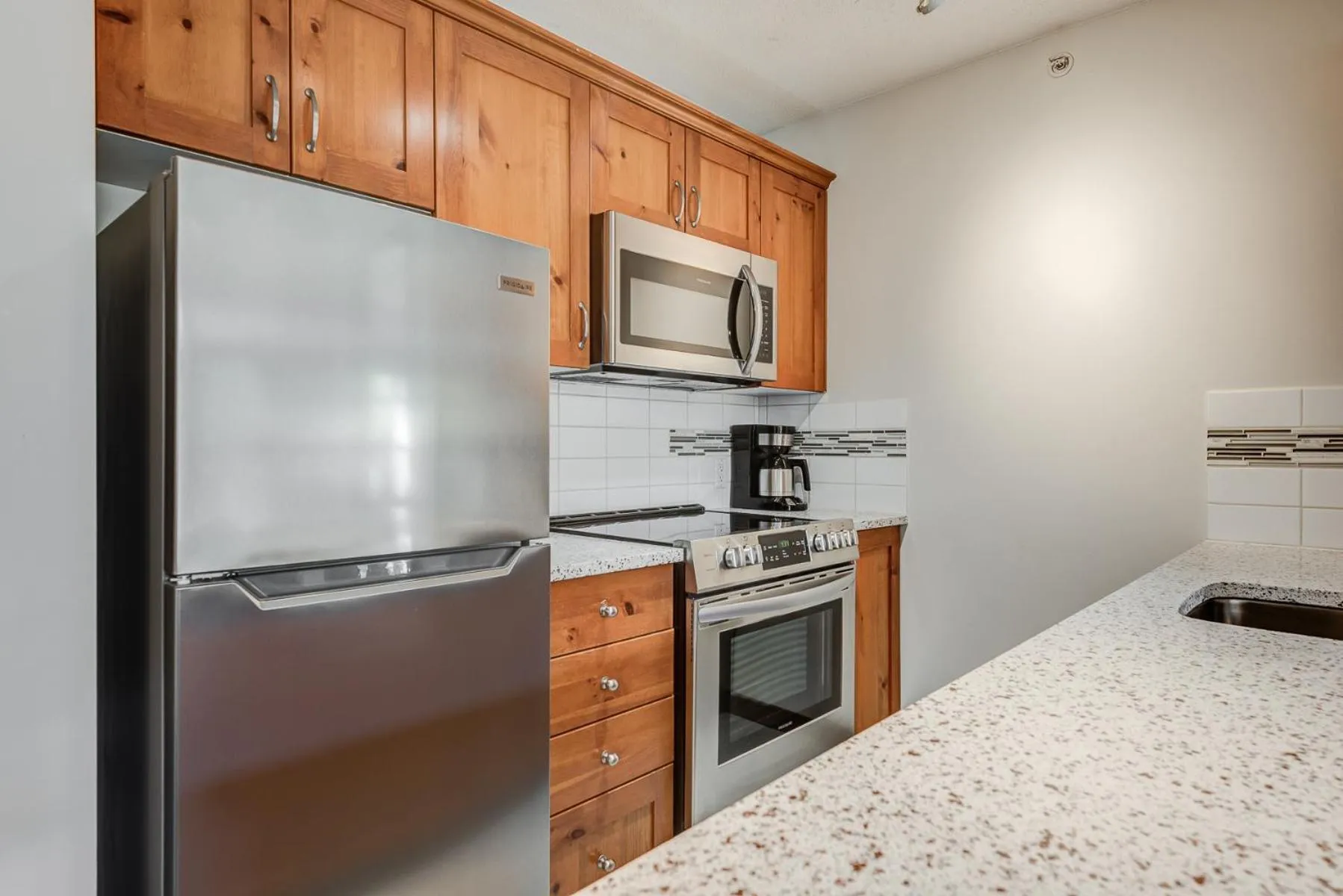 Kitchen or kitchenette in Blackcomb Springs Suites by CLIQUE
