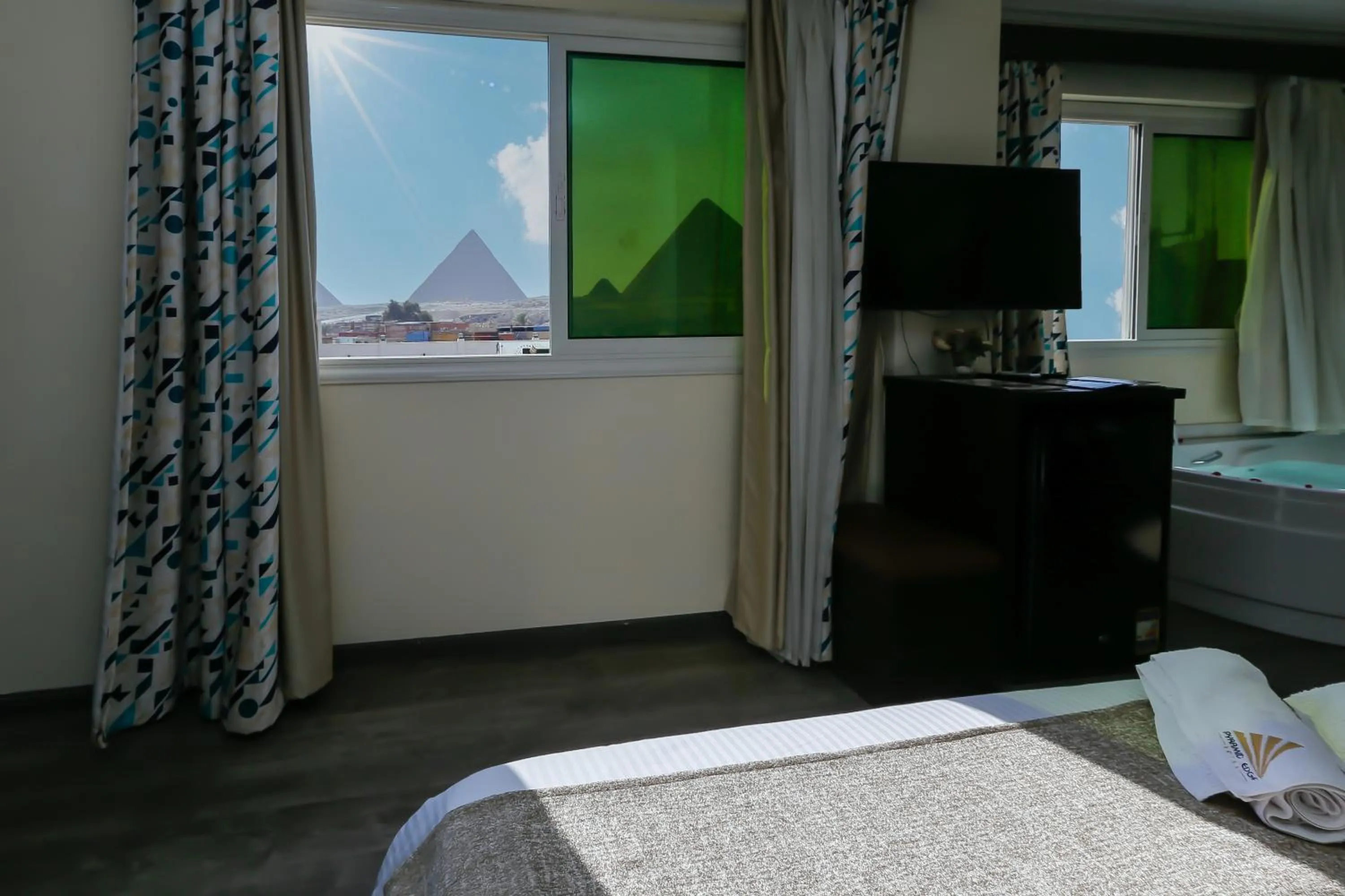 Communal lounge/ TV room, Bed in Pyramid Edge Hotel & Exclusive Pyramids View Rooftop
