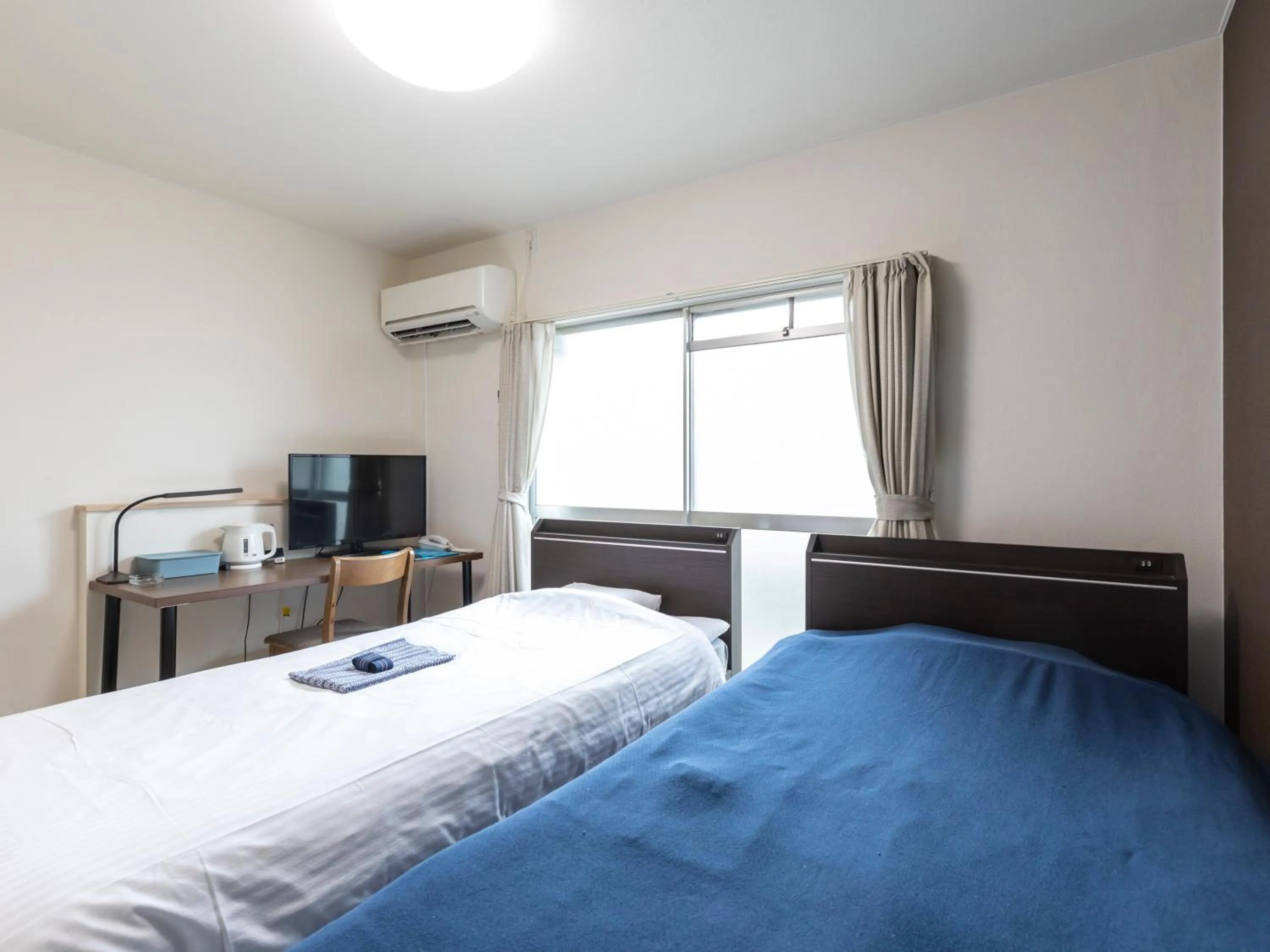 Bed in Tabist Motodai Business Hotel Kanonji