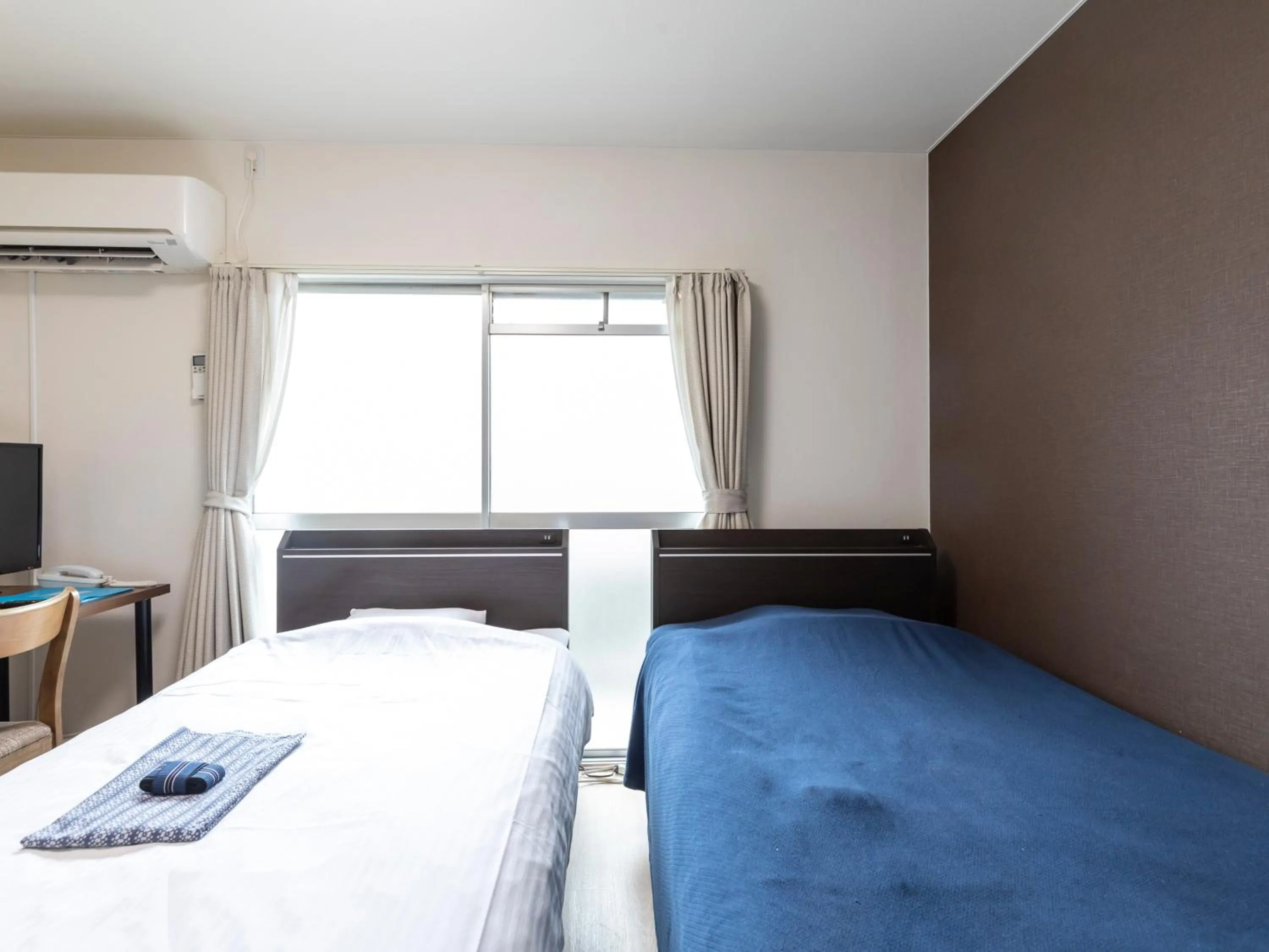 Bed in Tabist Motodai Business Hotel Kanonji