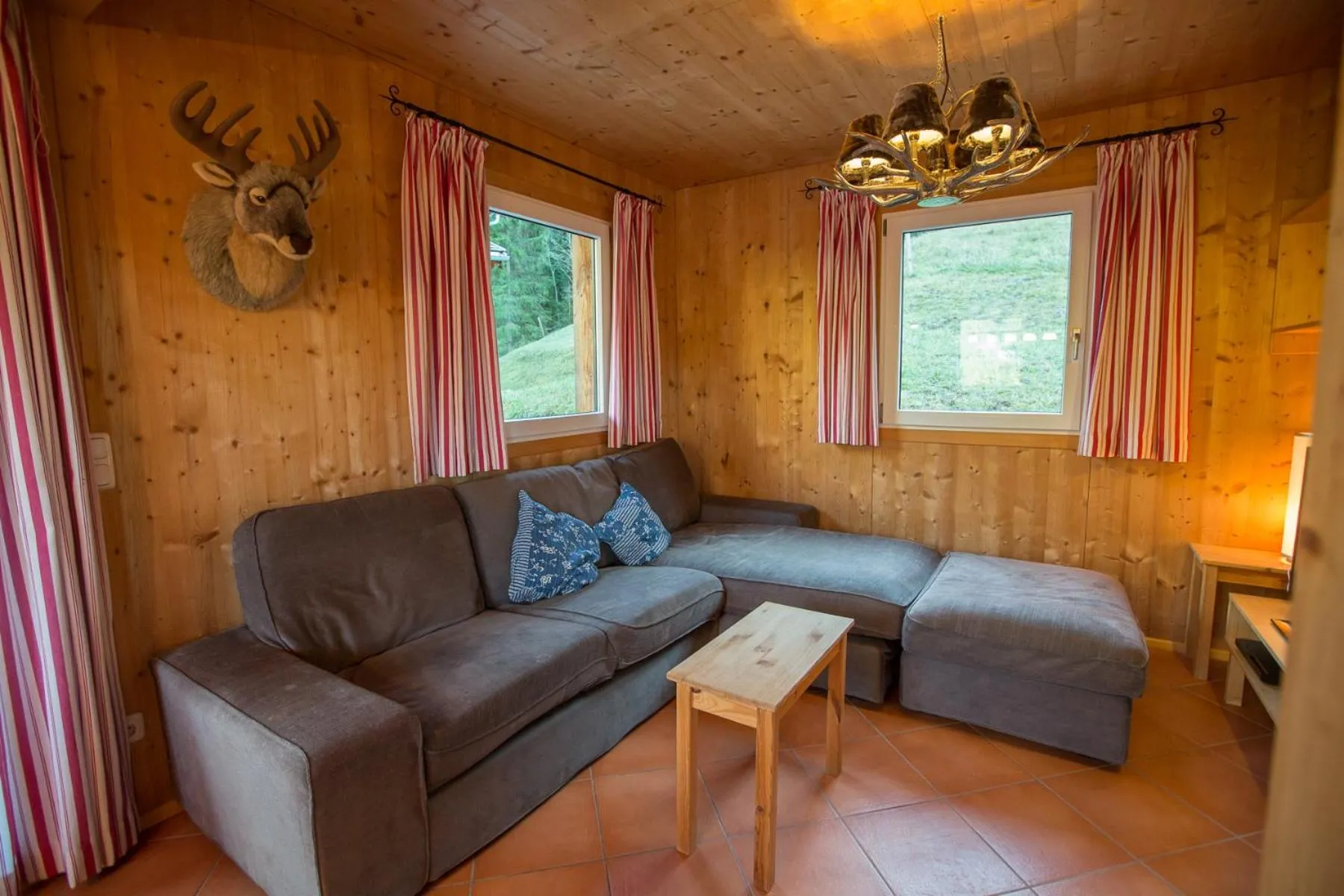 Living room in Alpendorf Dachstein West by ALPS RESORTS