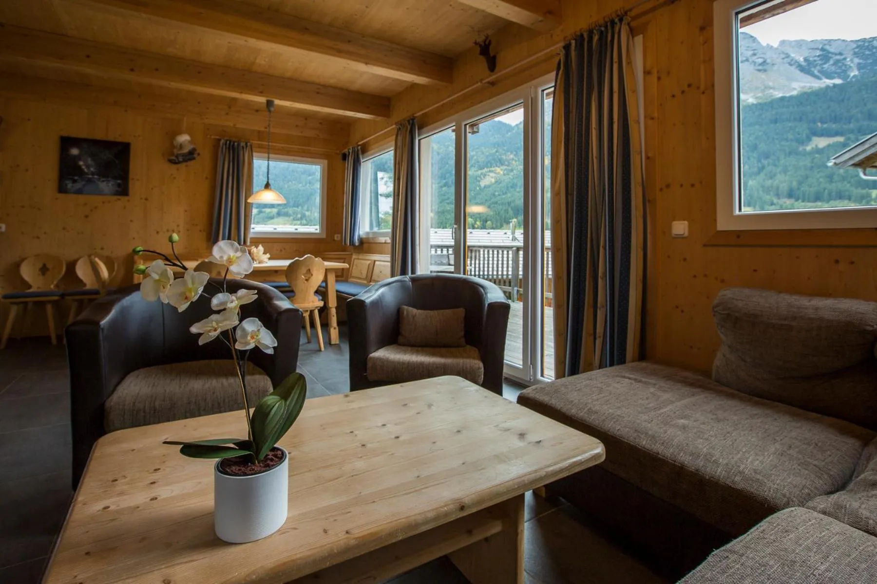 Living room in Alpendorf Dachstein West by ALPS RESORTS