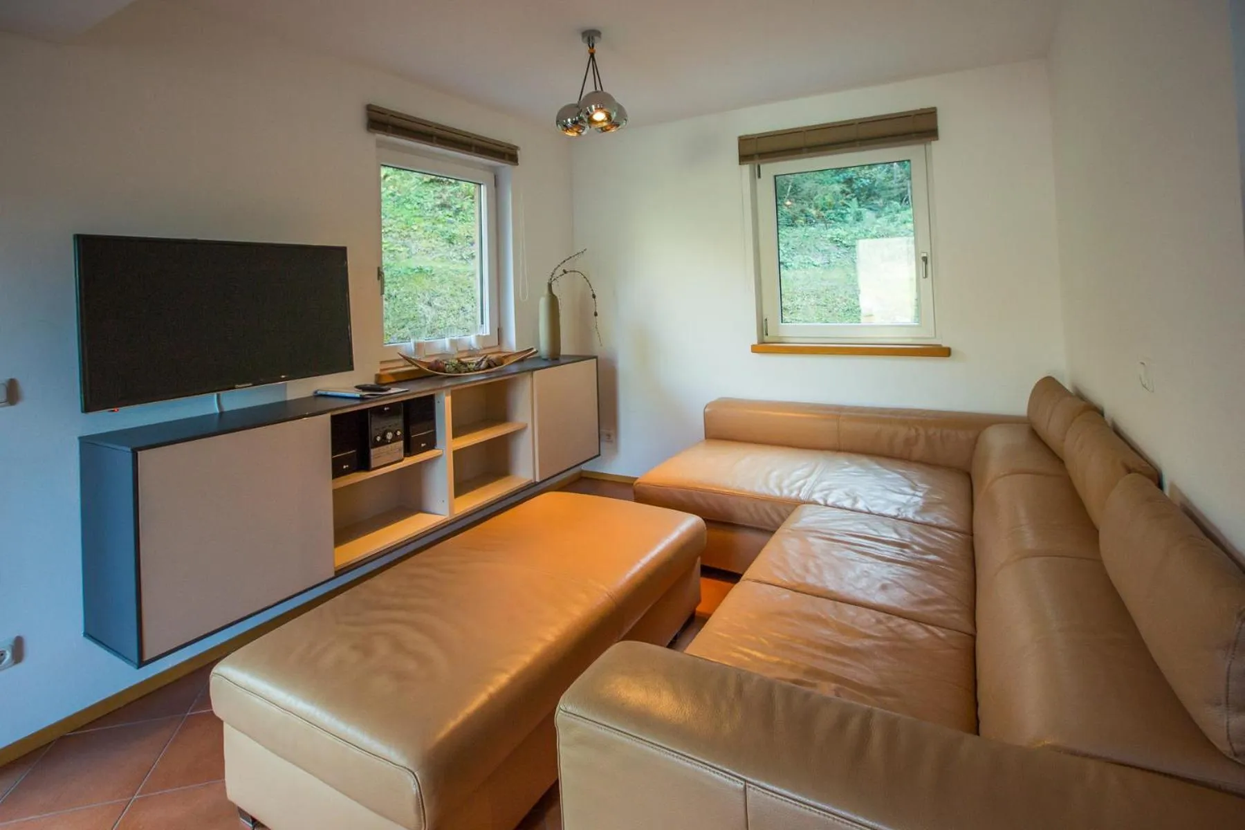 Living room in Alpendorf Dachstein West by ALPS RESORTS