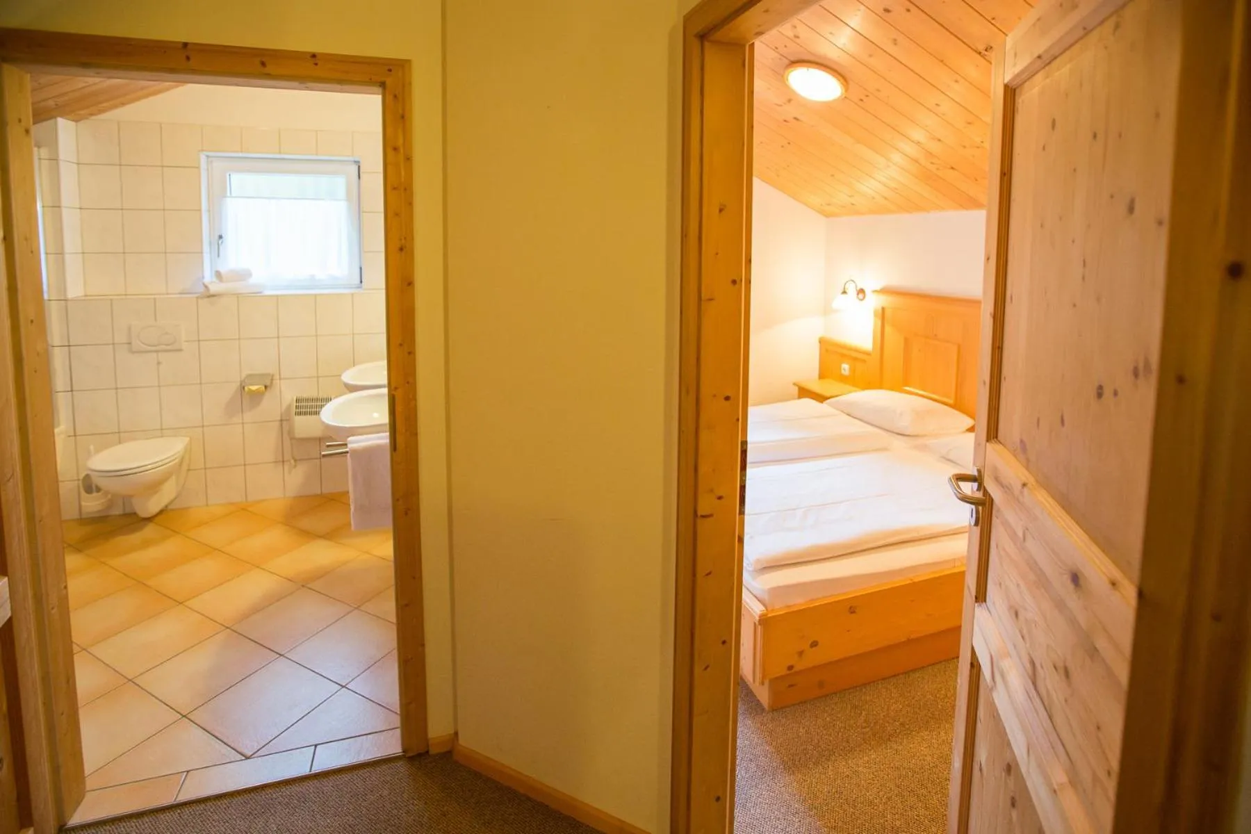 Bathroom, Bed in Alpendorf Dachstein West by ALPS RESORTS
