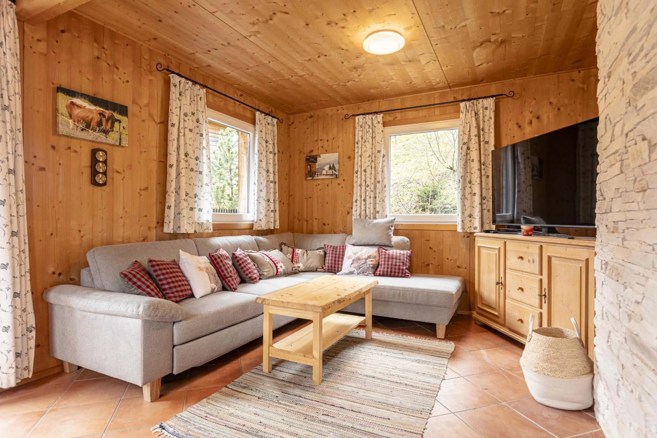 Living room in Alpendorf Dachstein West by ALPS RESORTS