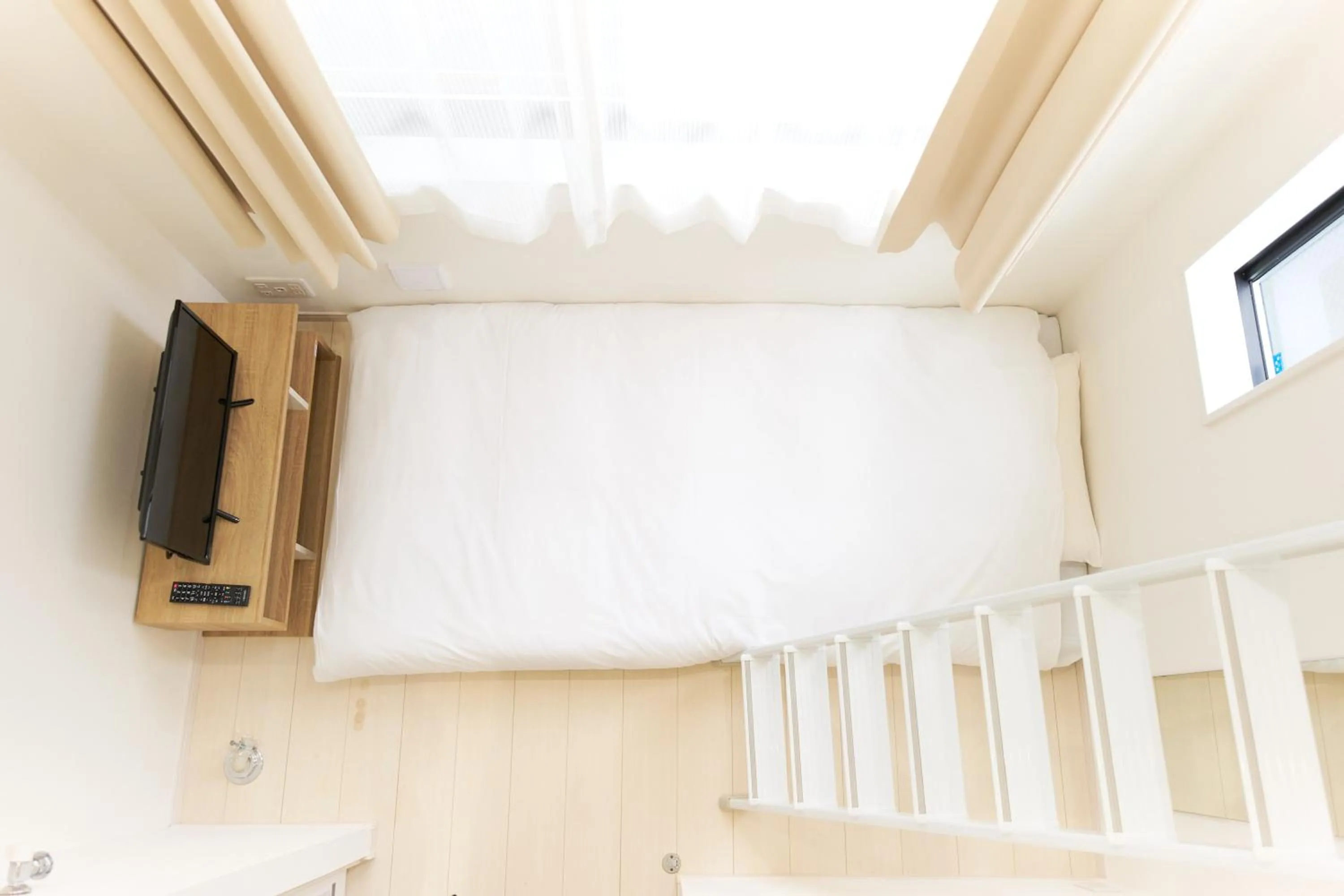 Bed in Nano North Shinjuku Apartment by Tranova