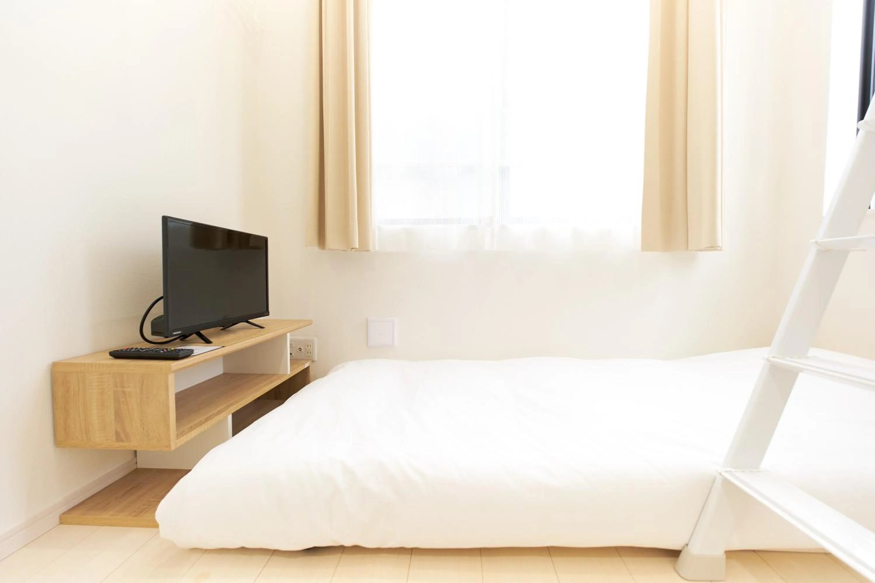 Bed in Nano North Shinjuku Apartment by Tranova