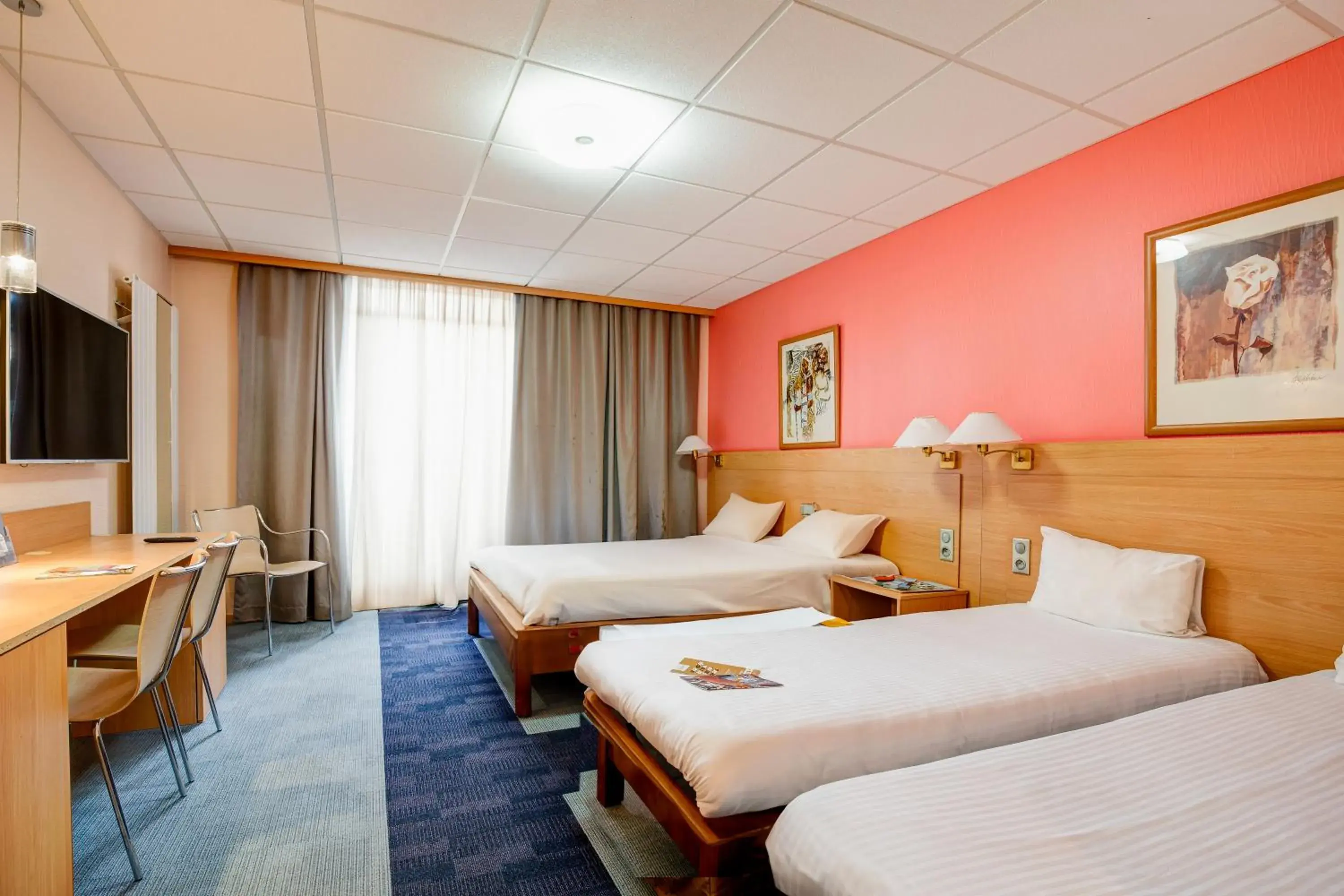 Standard Room with One Double Bed and Two Single Beds in Kyriad Montbeliard Sochaux Standard Room with One Double Bed and Two Single Beds in Kyriad Montbeliard Sochaux