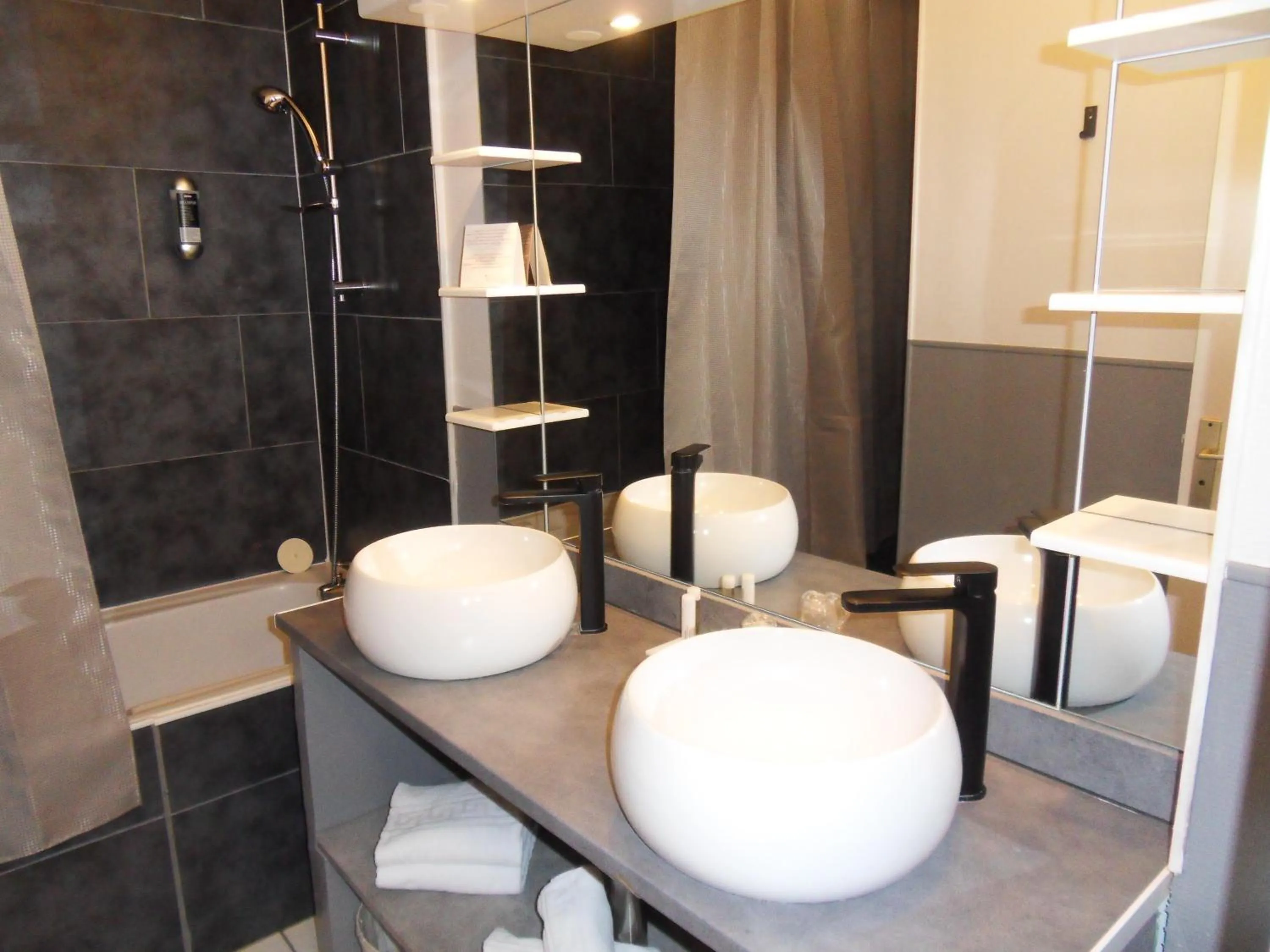 Bathroom in Logis Hôtel Restaurant Les Aubuns