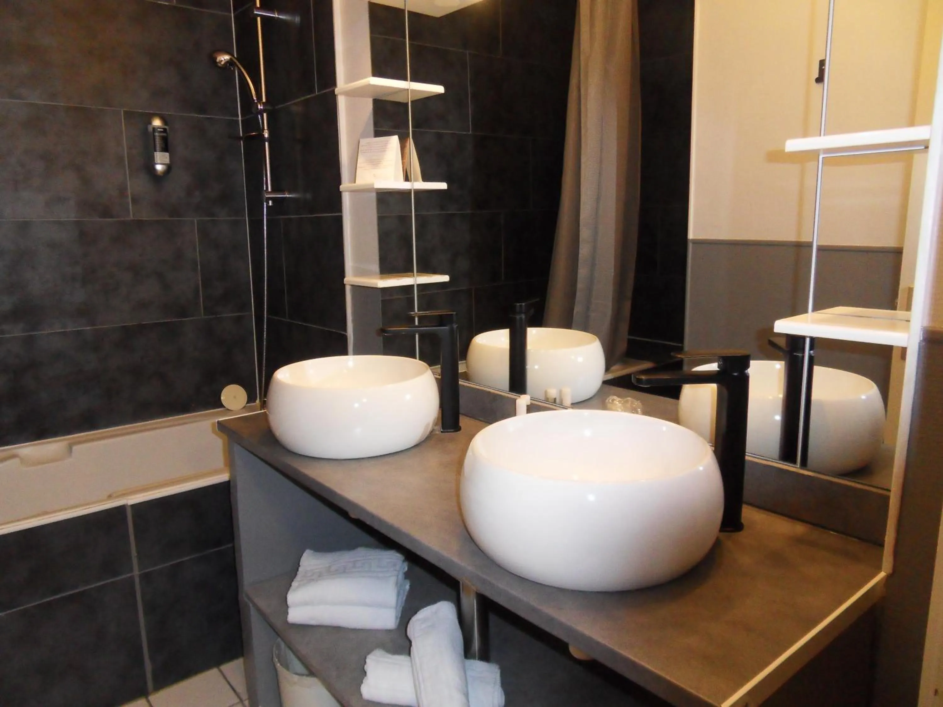 Bathroom in Logis Hôtel Restaurant Les Aubuns