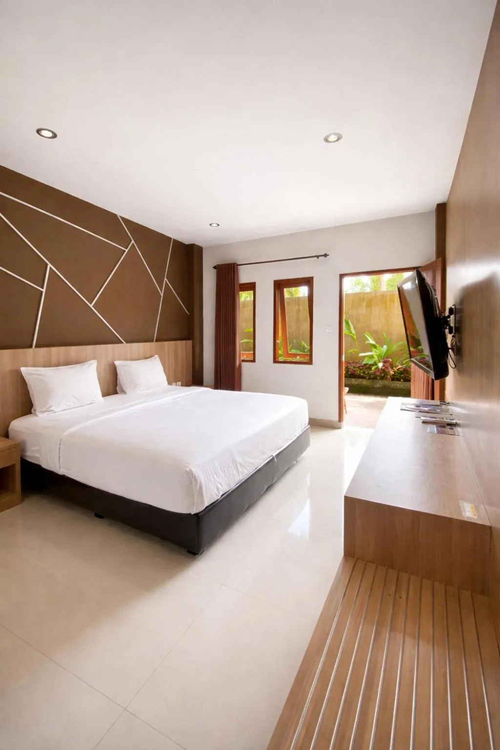 Bed in Grand Kuta Hotel Lombok - Pool - 43 inch Google TV - Strong 60Mbps WiFi - New Enhanced Management