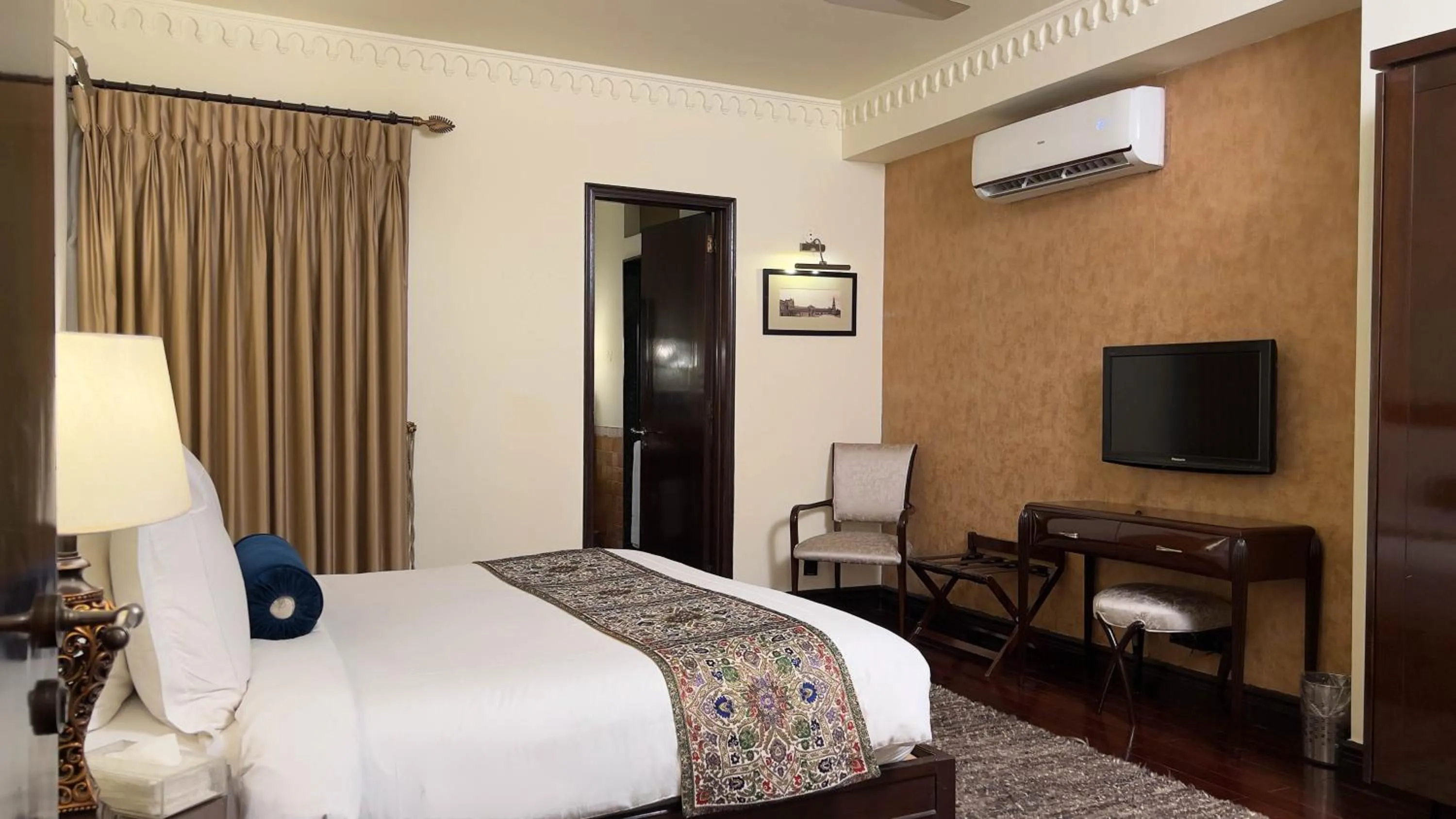 Bed in Heritage Luxury Suites All Suite Hotel